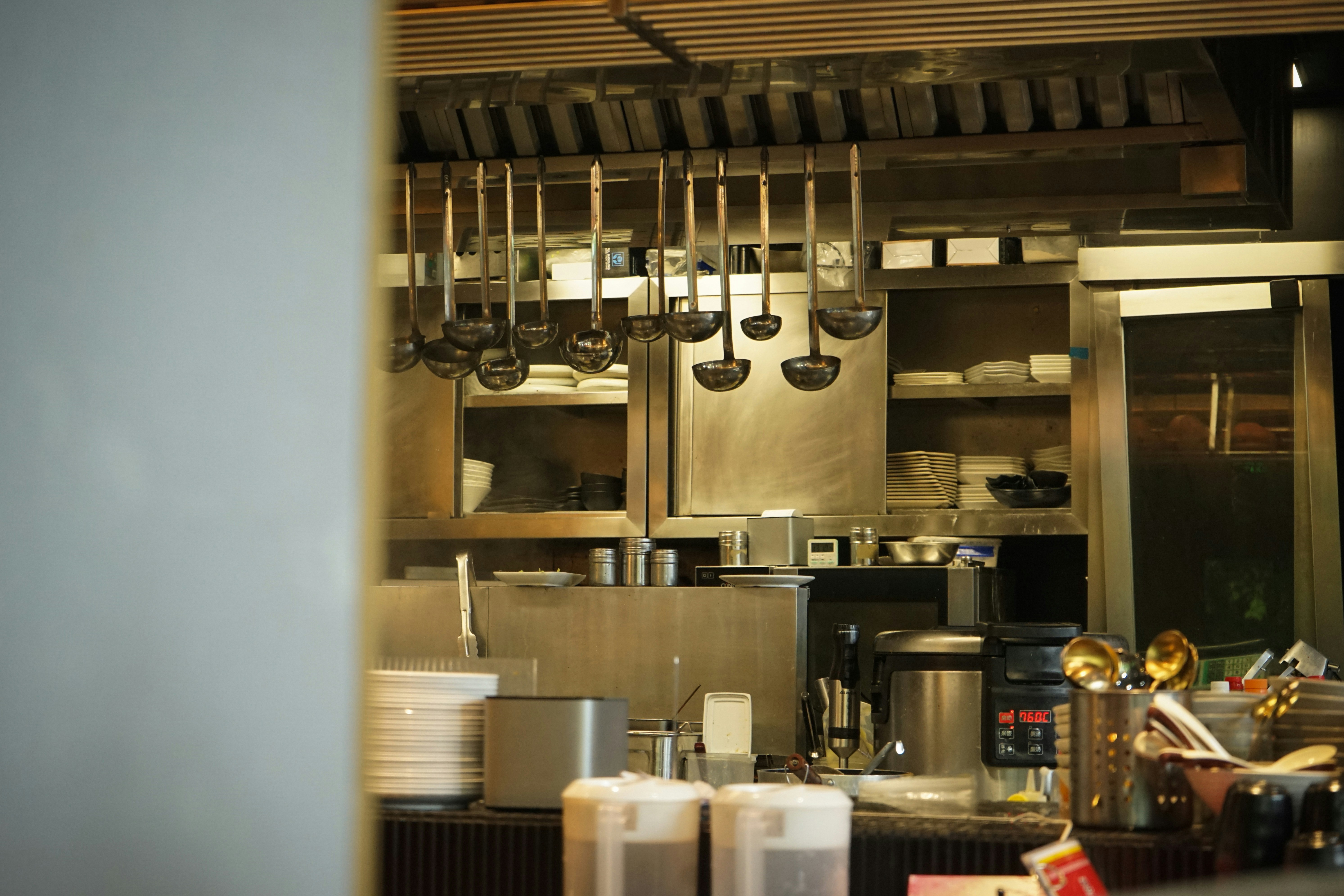 Kitchen utensils hang in a professional kitchen
