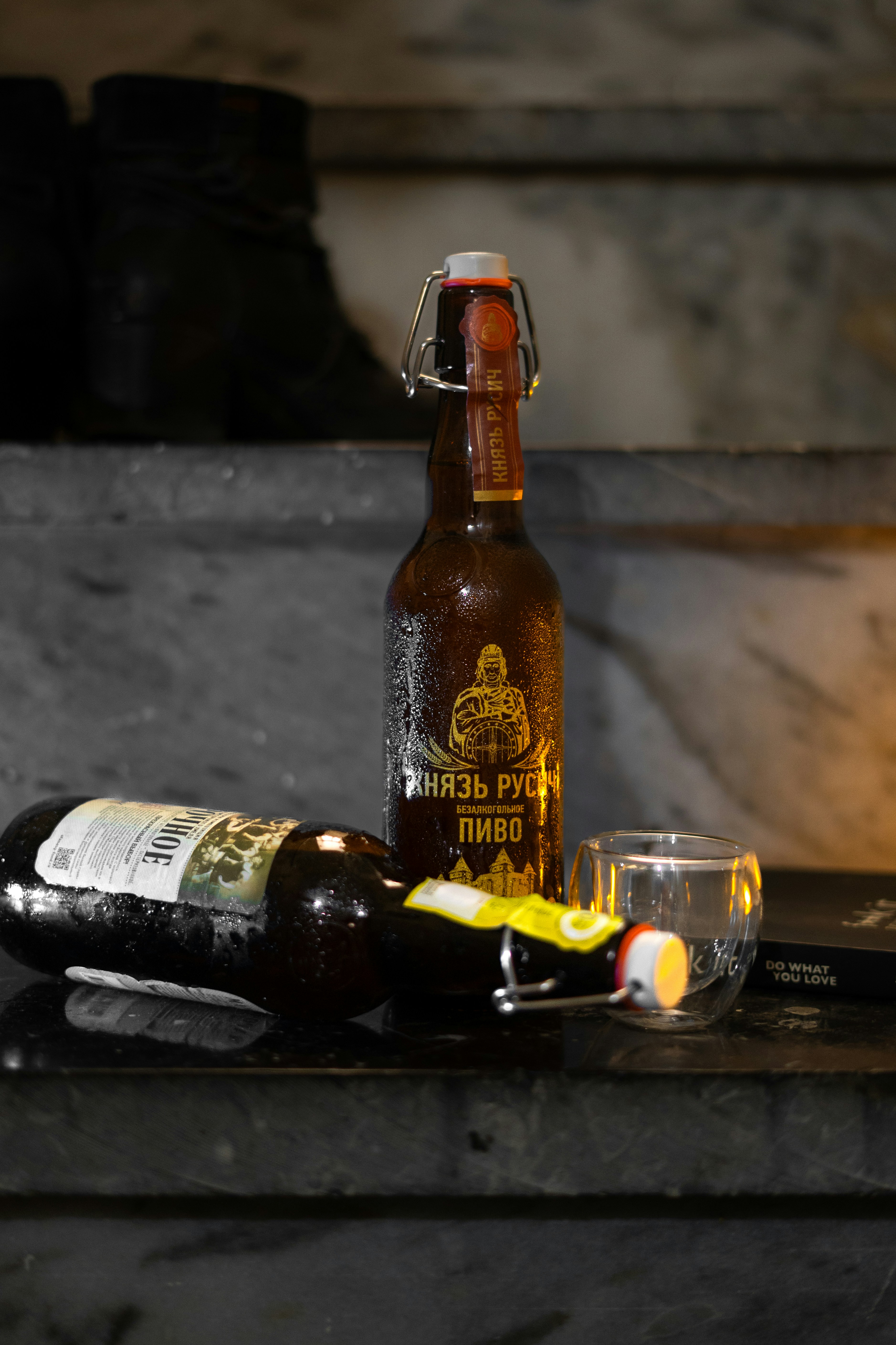 Two bottles of beer with a glass.