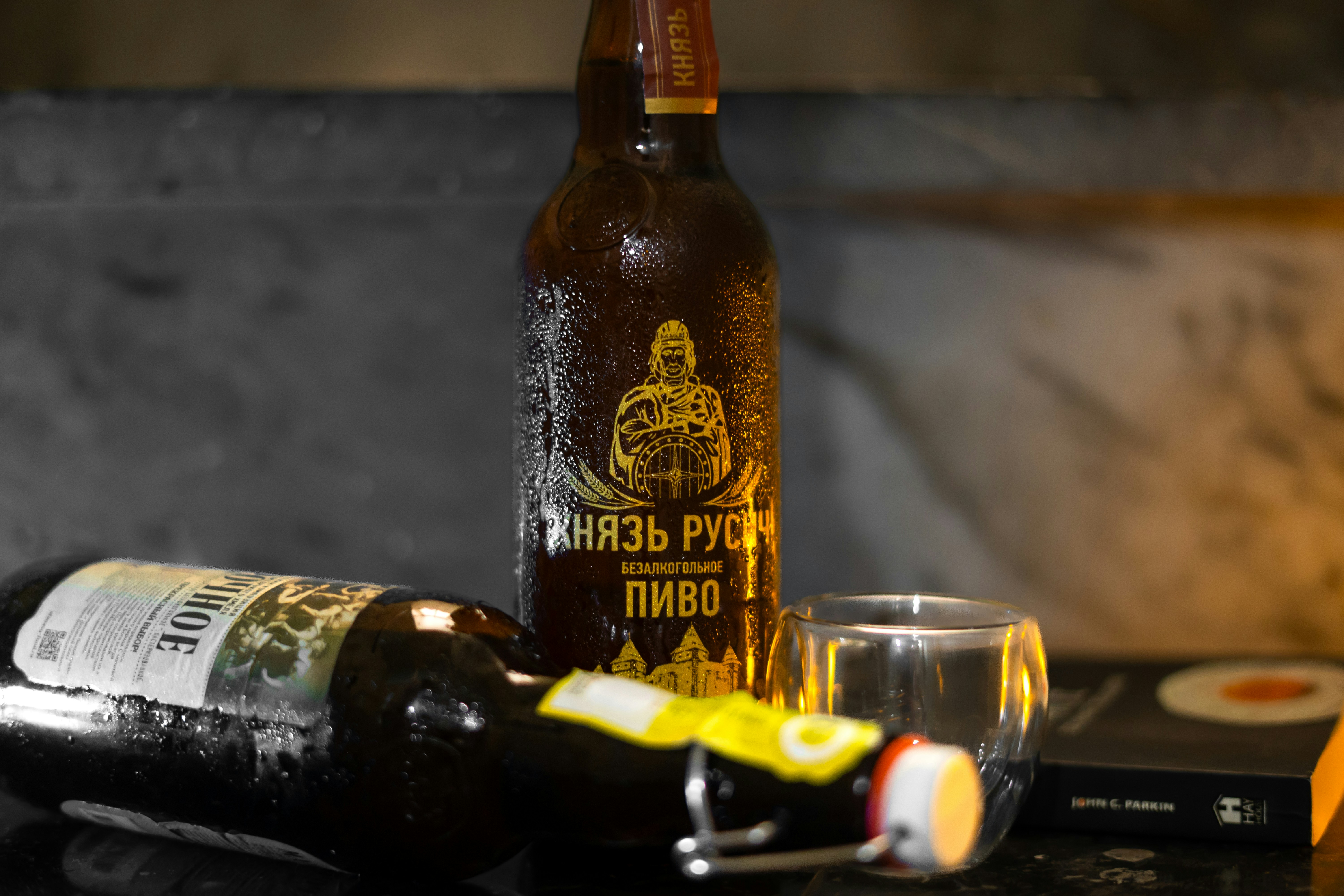 Beer bottles, a glass, and a book are displayed.