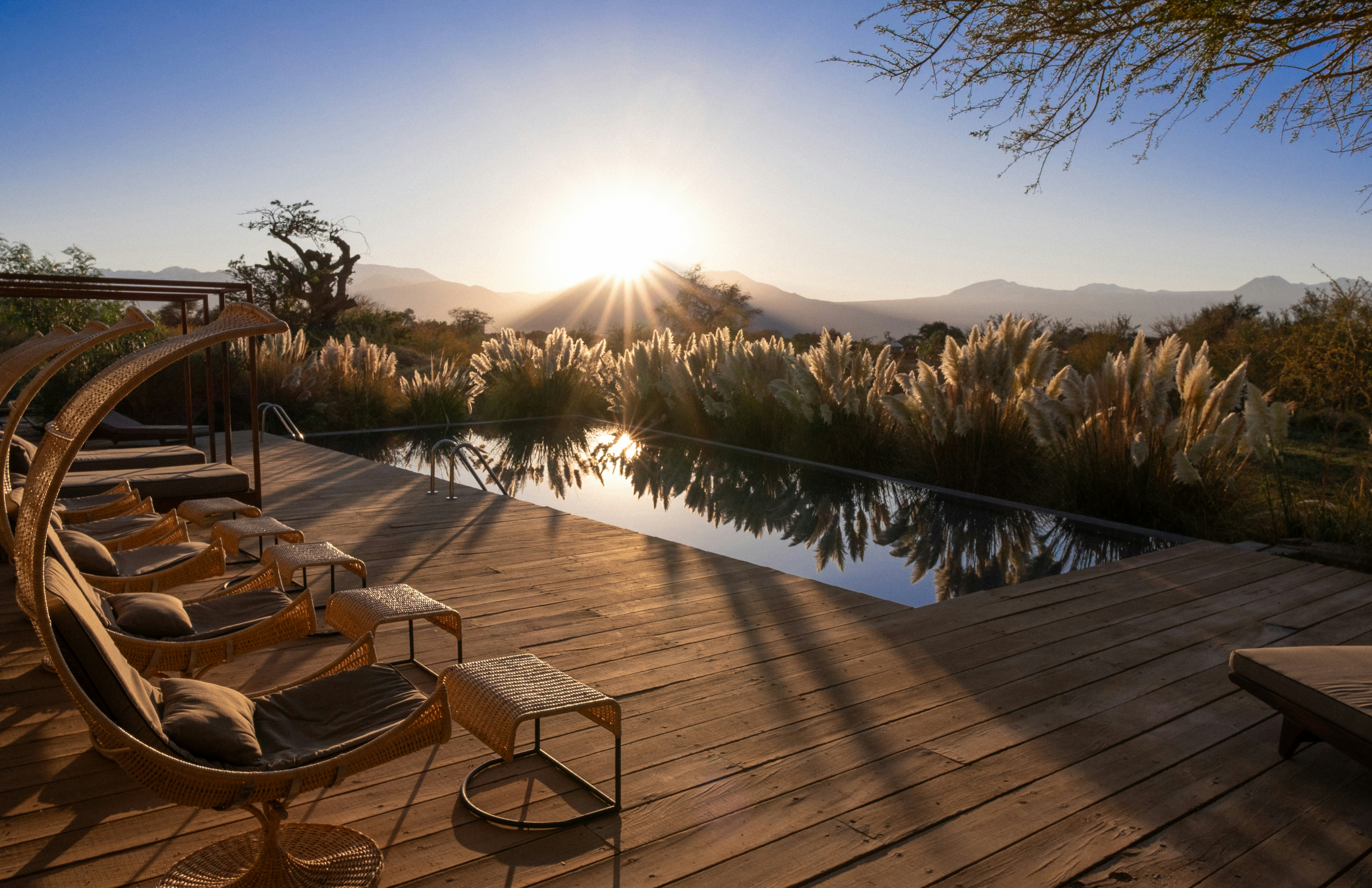 Sunset view over a pool and beautiful landscape.