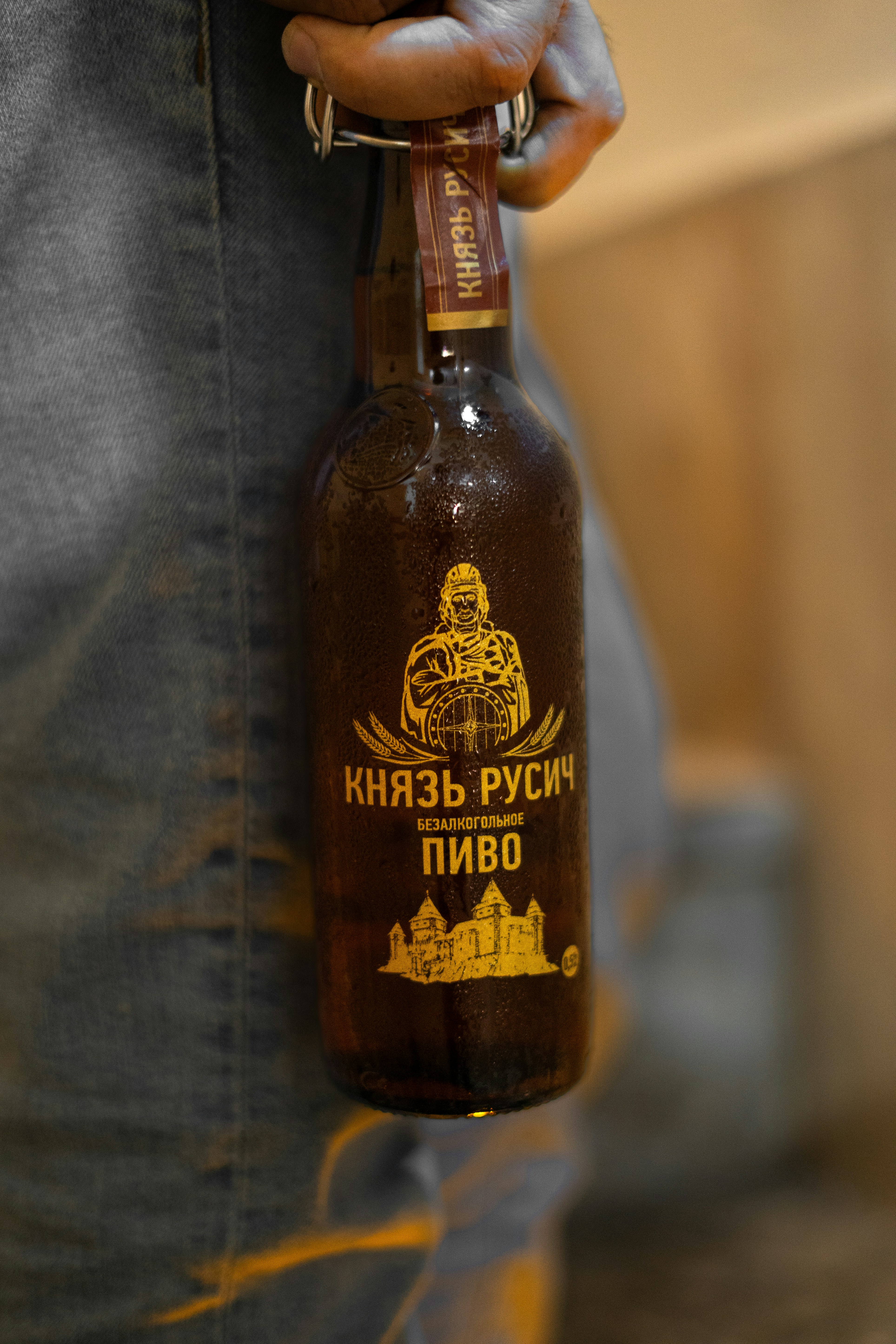 Someone is holding a bottle of russian beer.
