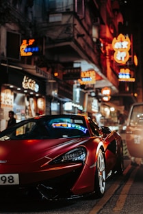 A red sports car shines bright in the city.