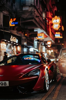 A red sports car shines bright in the city.