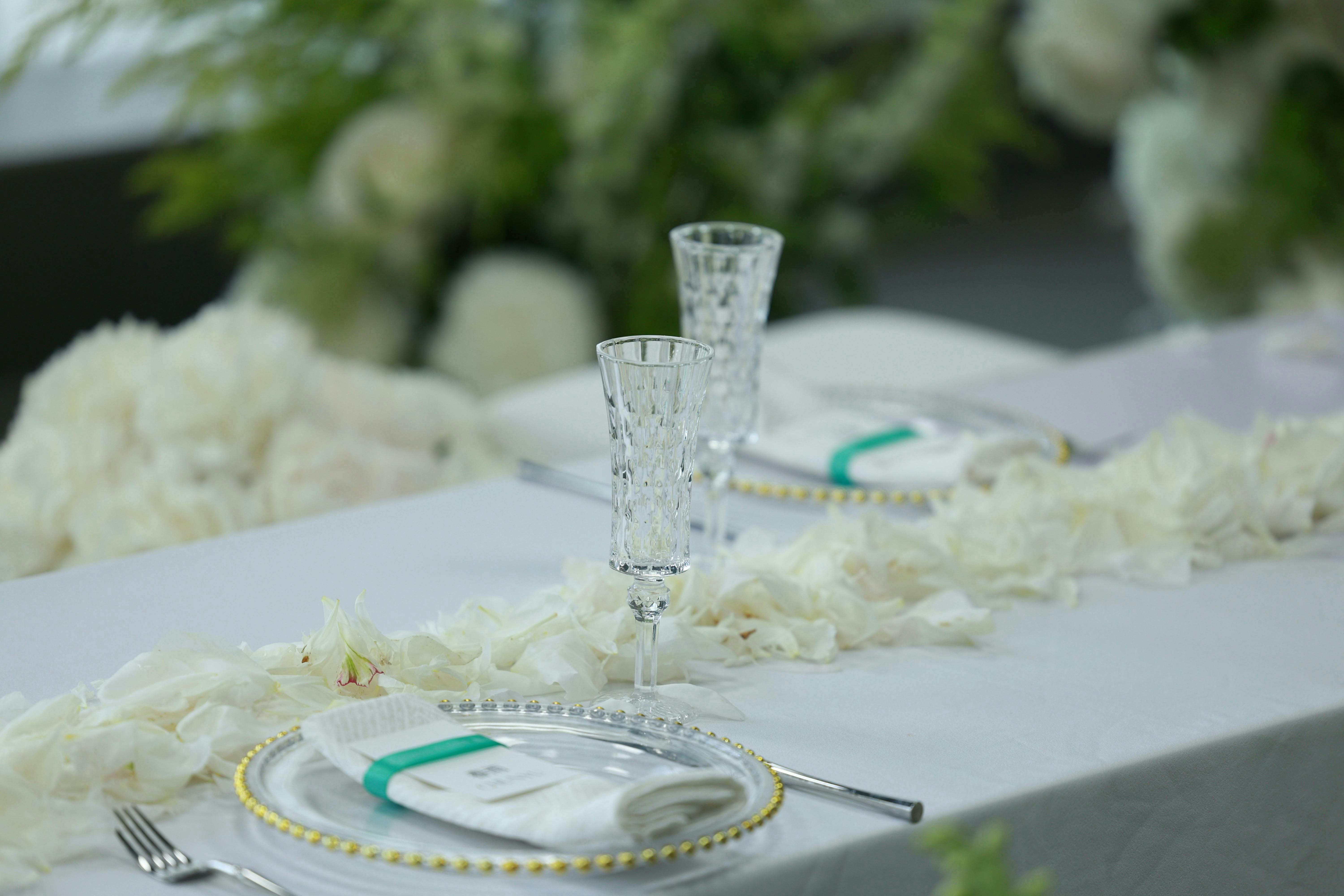 Wedding table setting with champagne flutes and decor.