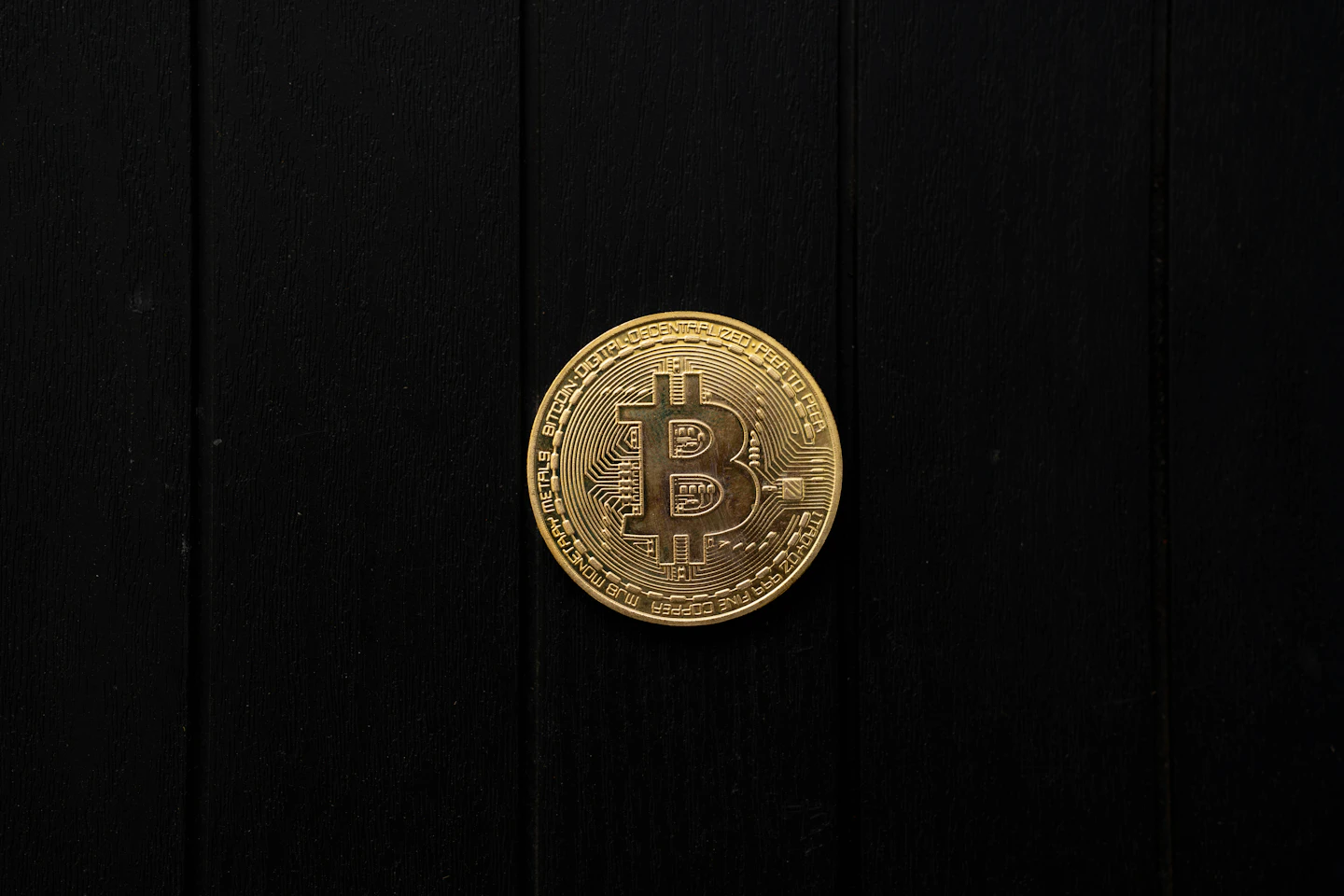 Single Bitcoin-themed collectible coin against a dark background