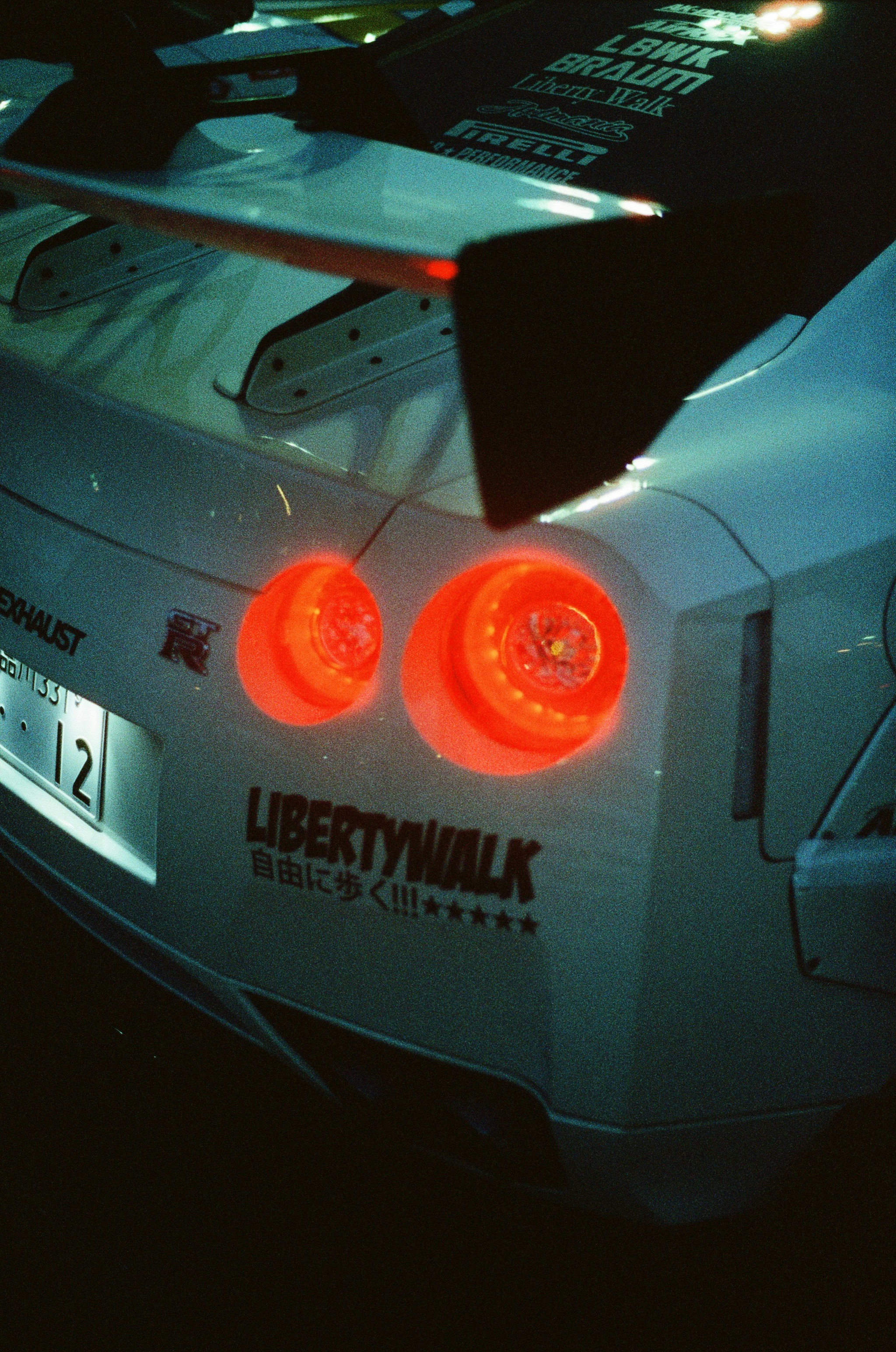 A nissan sports car with lit taillights.