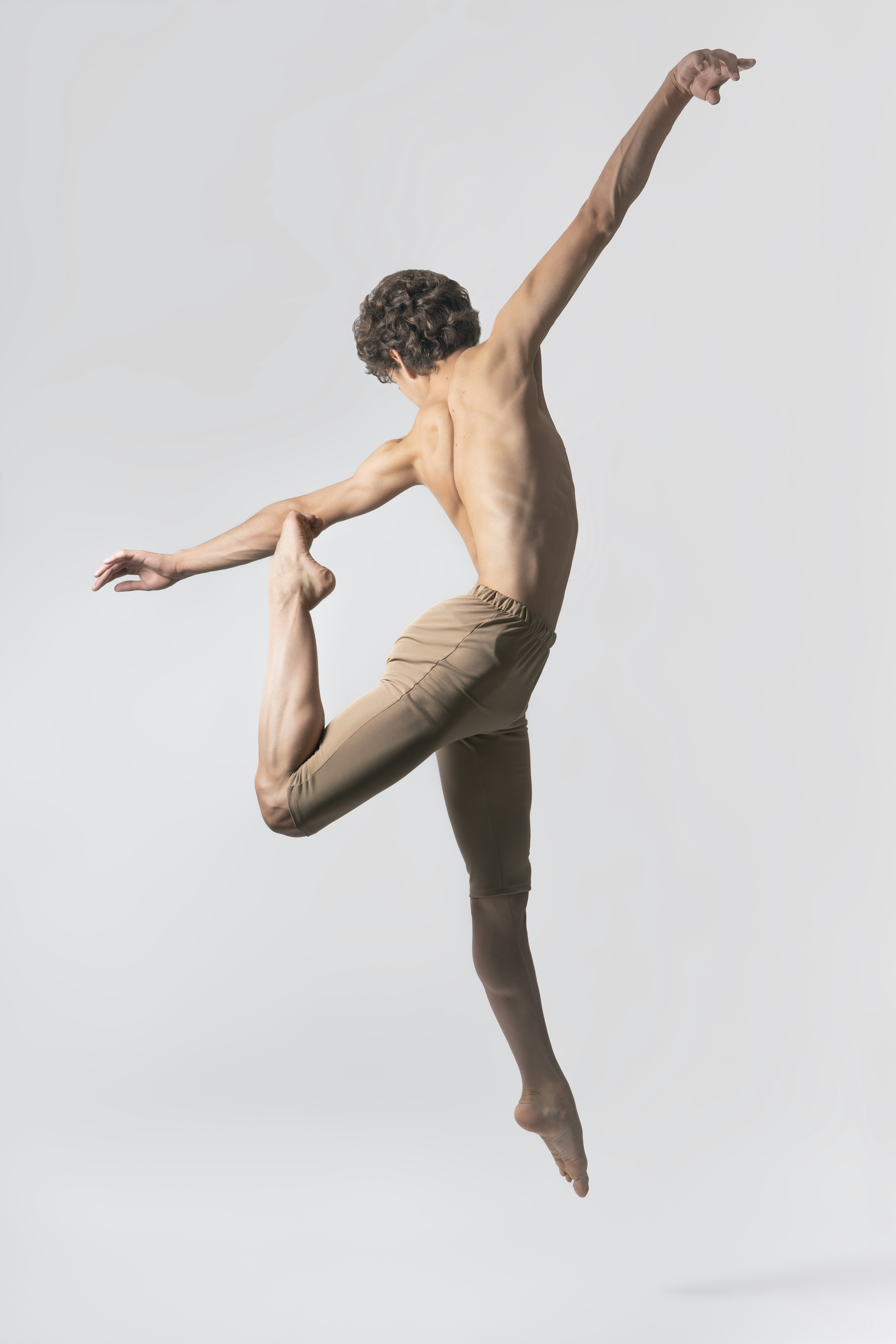 Ballet dancer leaping gracefully in midair