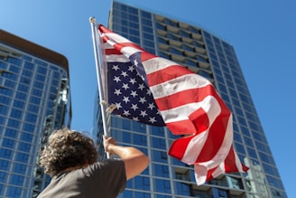 A person waves the american flag proudly.