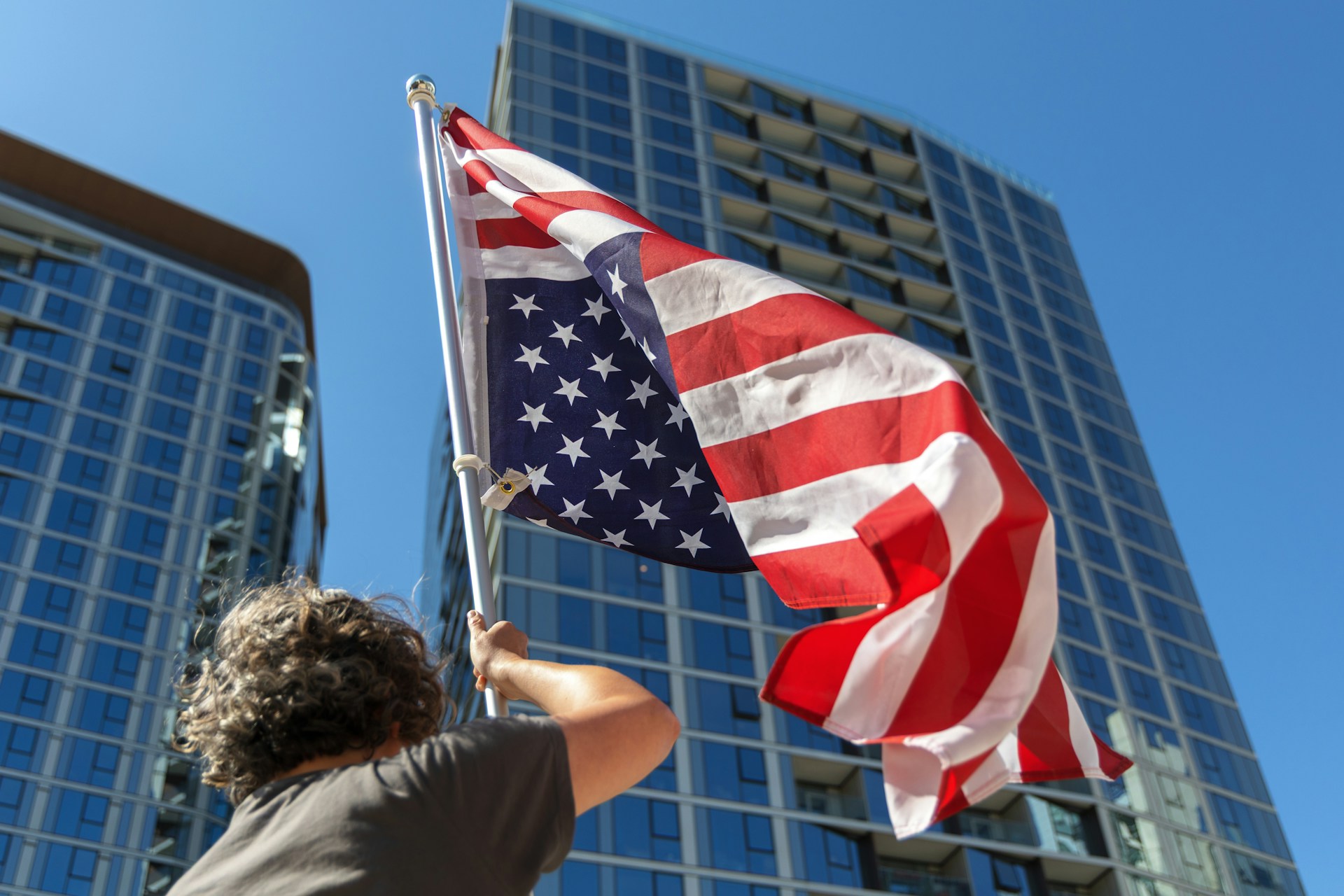 A person waves the american flag proudly.