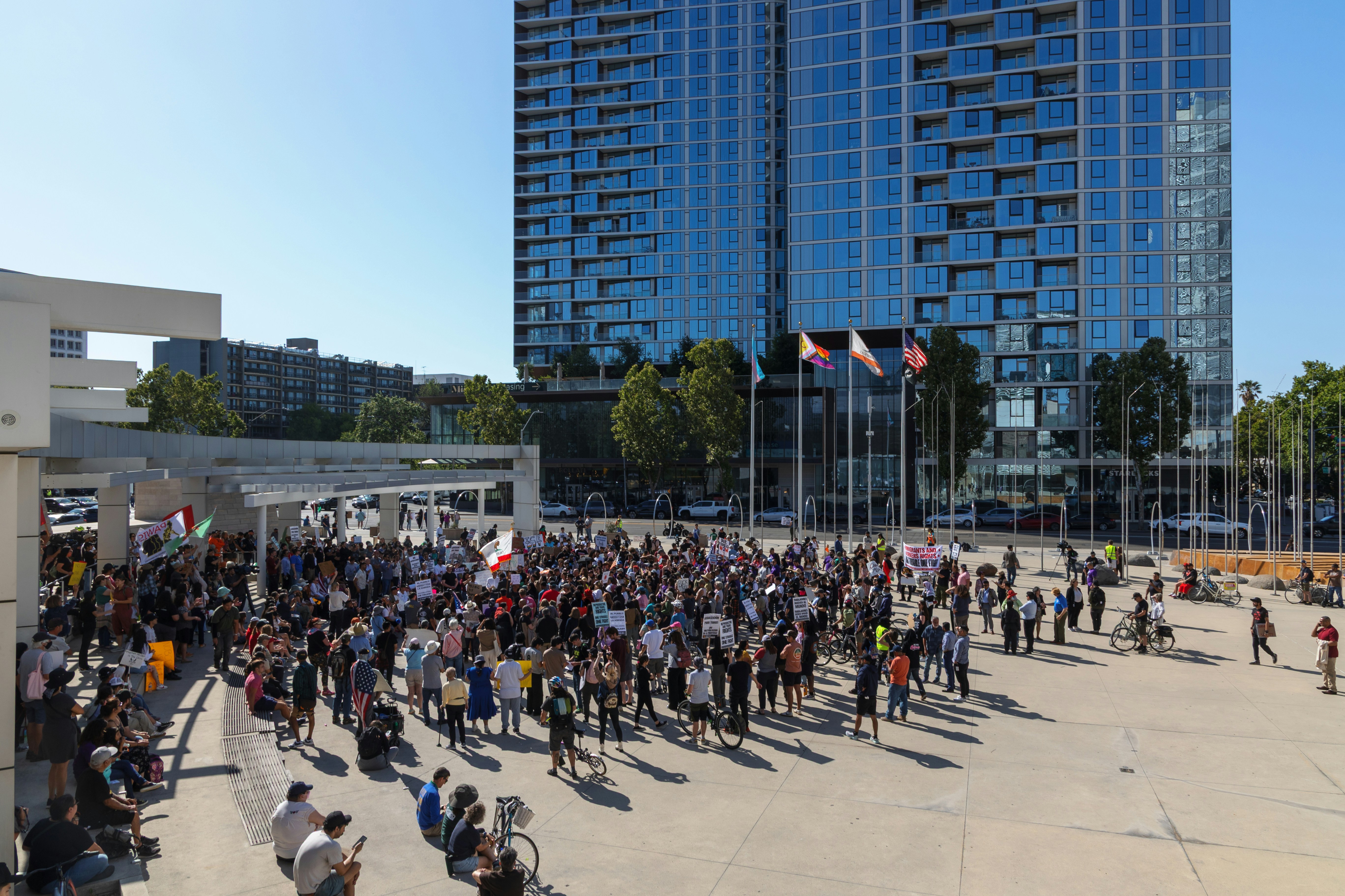 A large crowd protests in front of skyscrapers. photo – Free Ice Image ...
