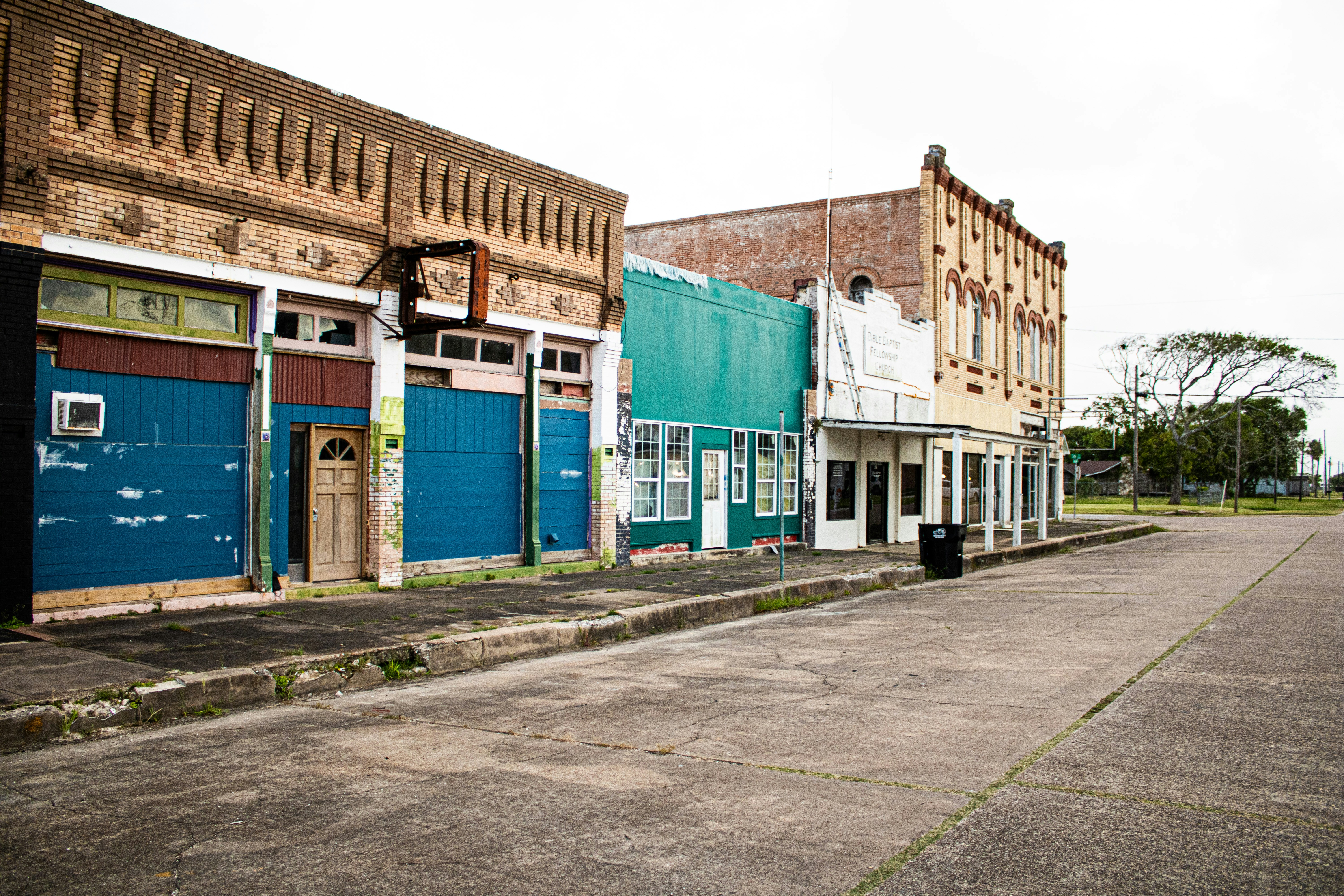 Old buildings line an empty street in a small town.