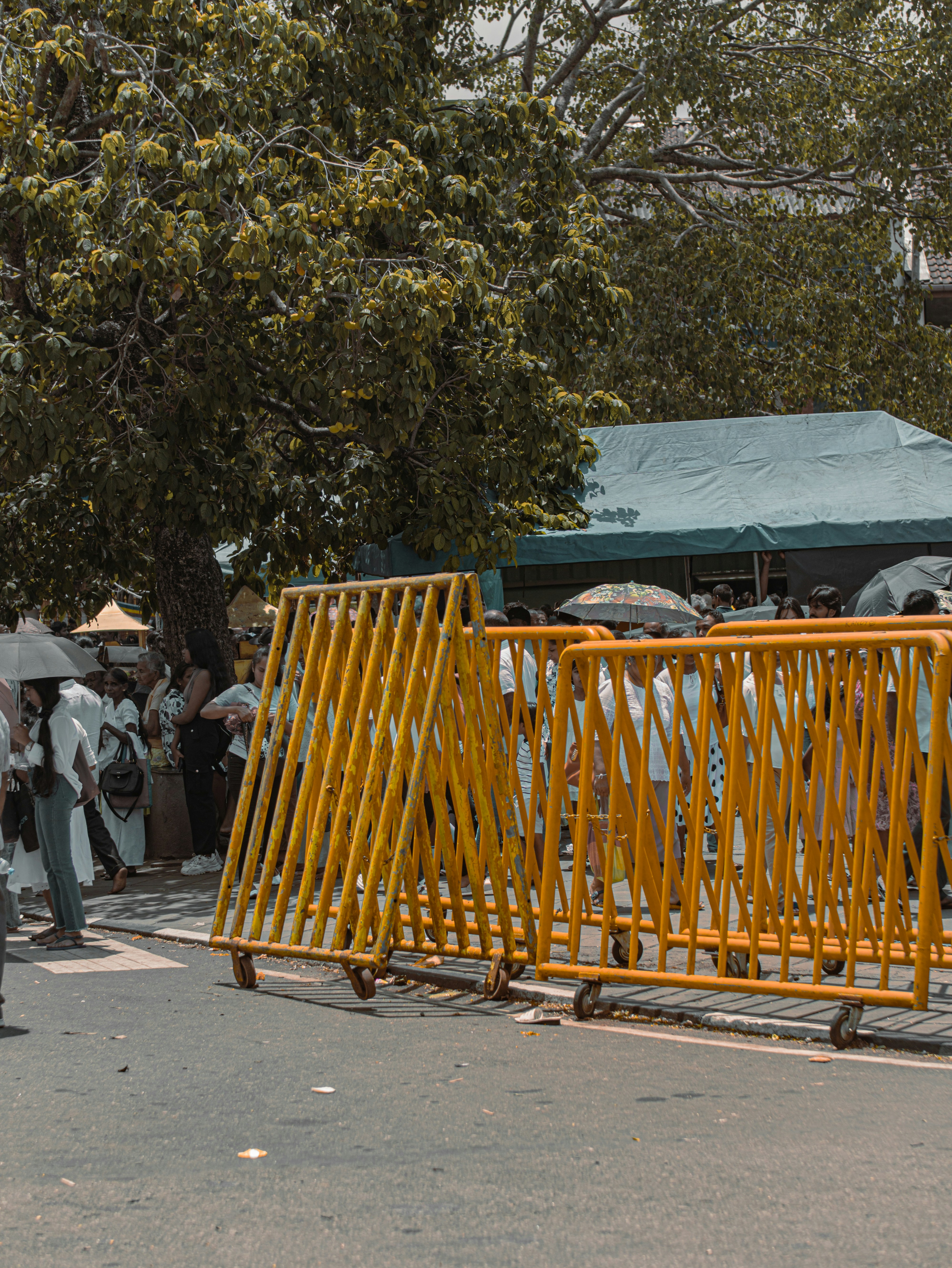 Barriers separate people on a street.