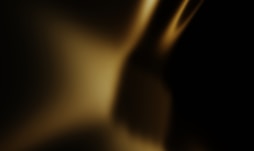 Abstract golden light shines against black.