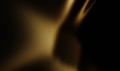 Abstract golden light shines against black.