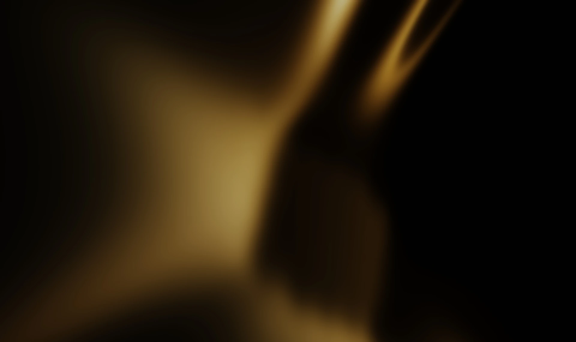 Abstract golden light shines against black.