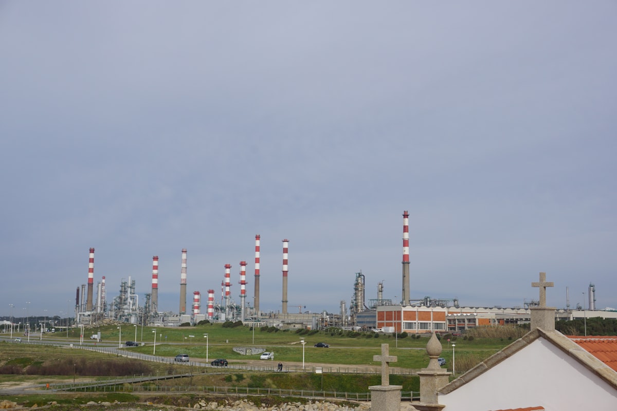 Industrial gas facility with chimneys under a cloudy sky
