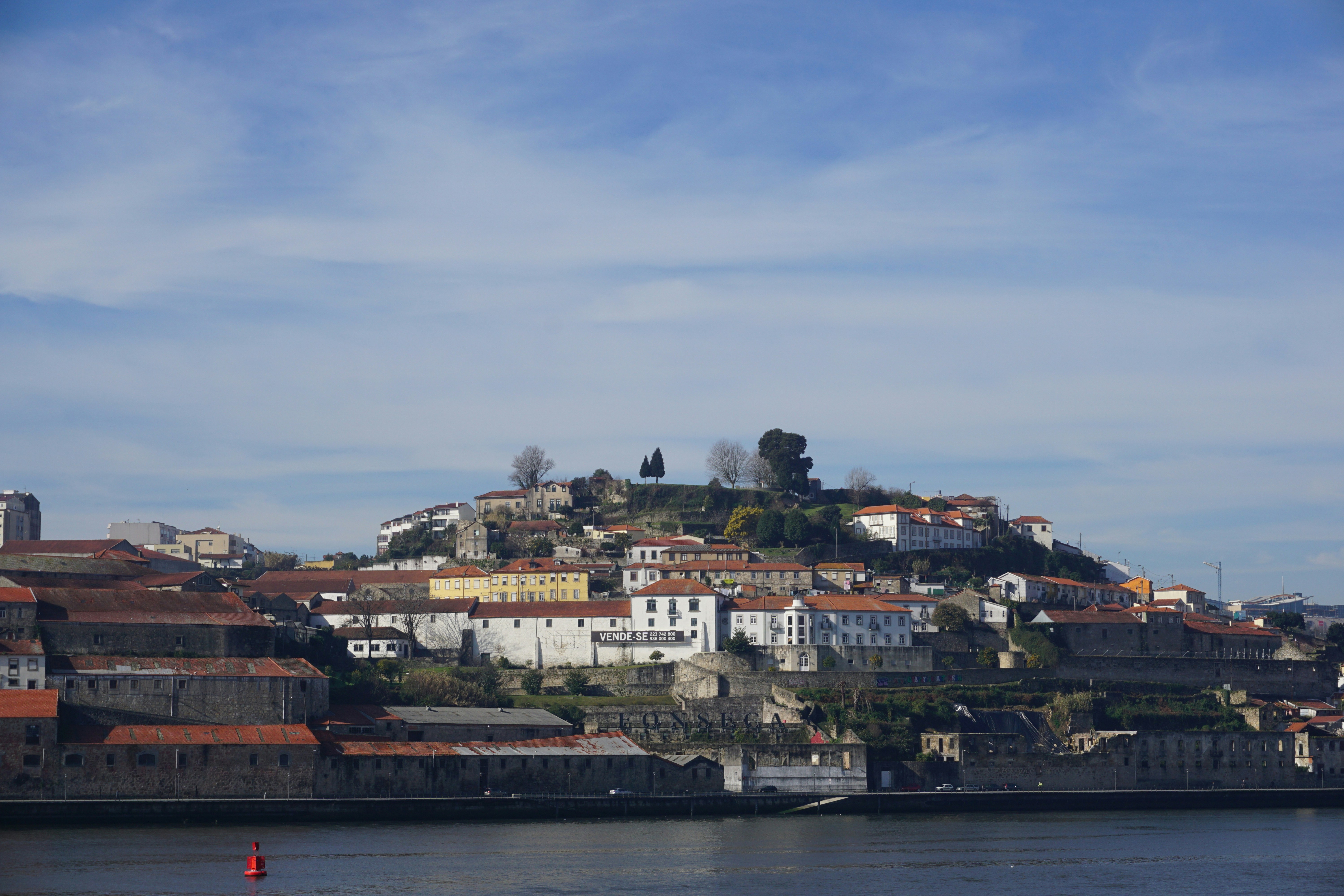 A hillside town is overlooking the water.