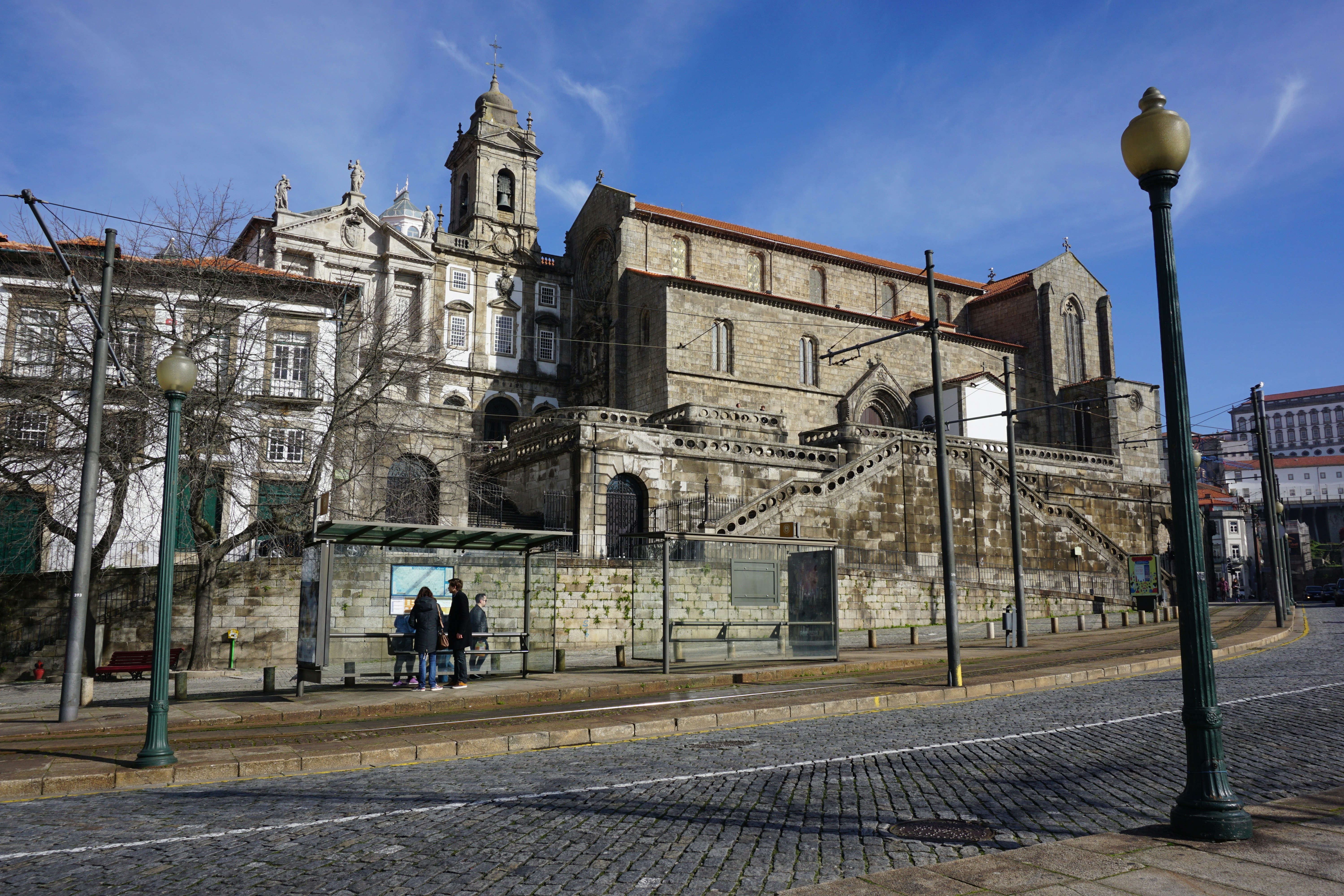 A historic building stands on a sunny street.