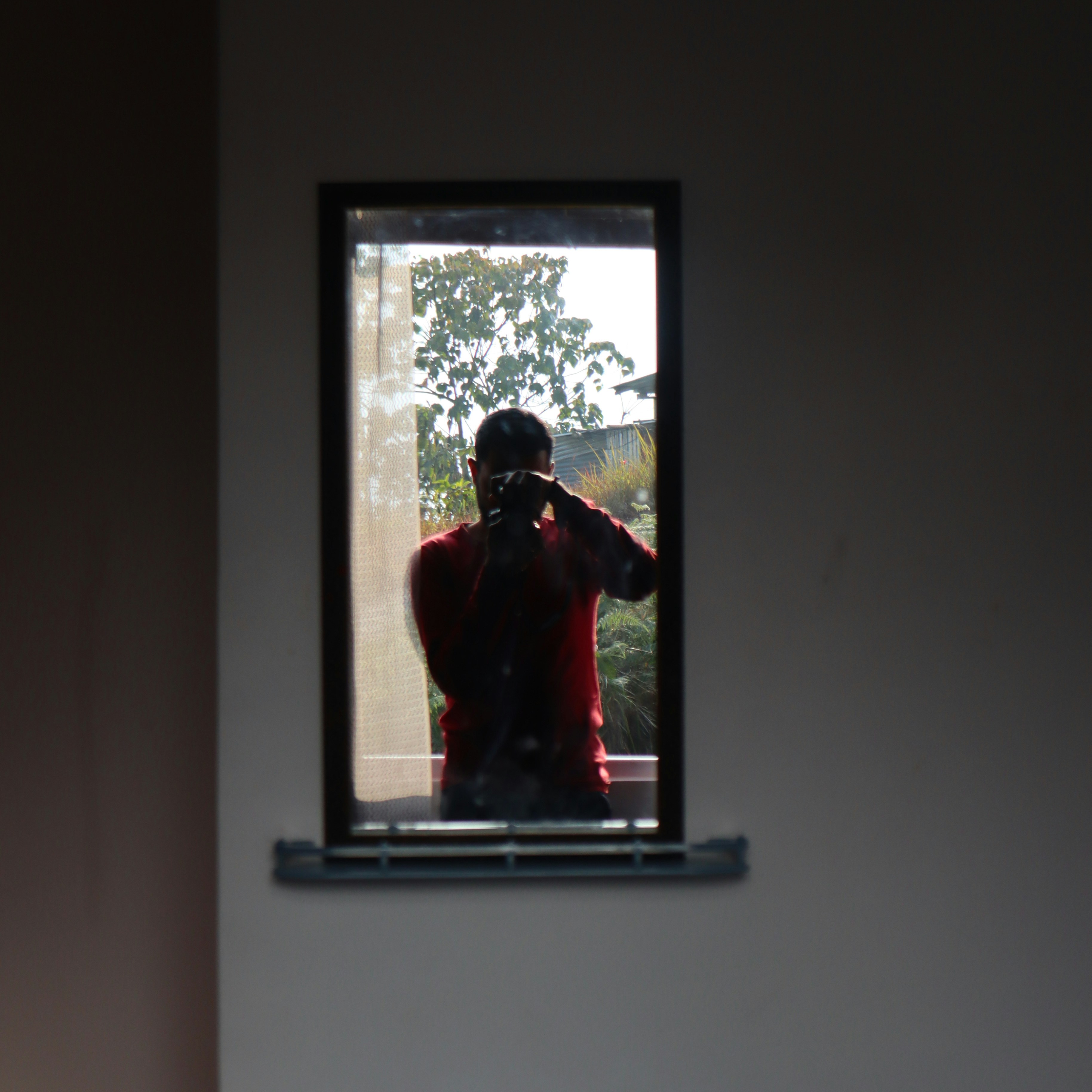 Person applying privacy window film to glass surface