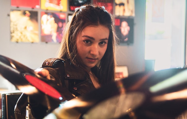 A woman selects a vinyl record.