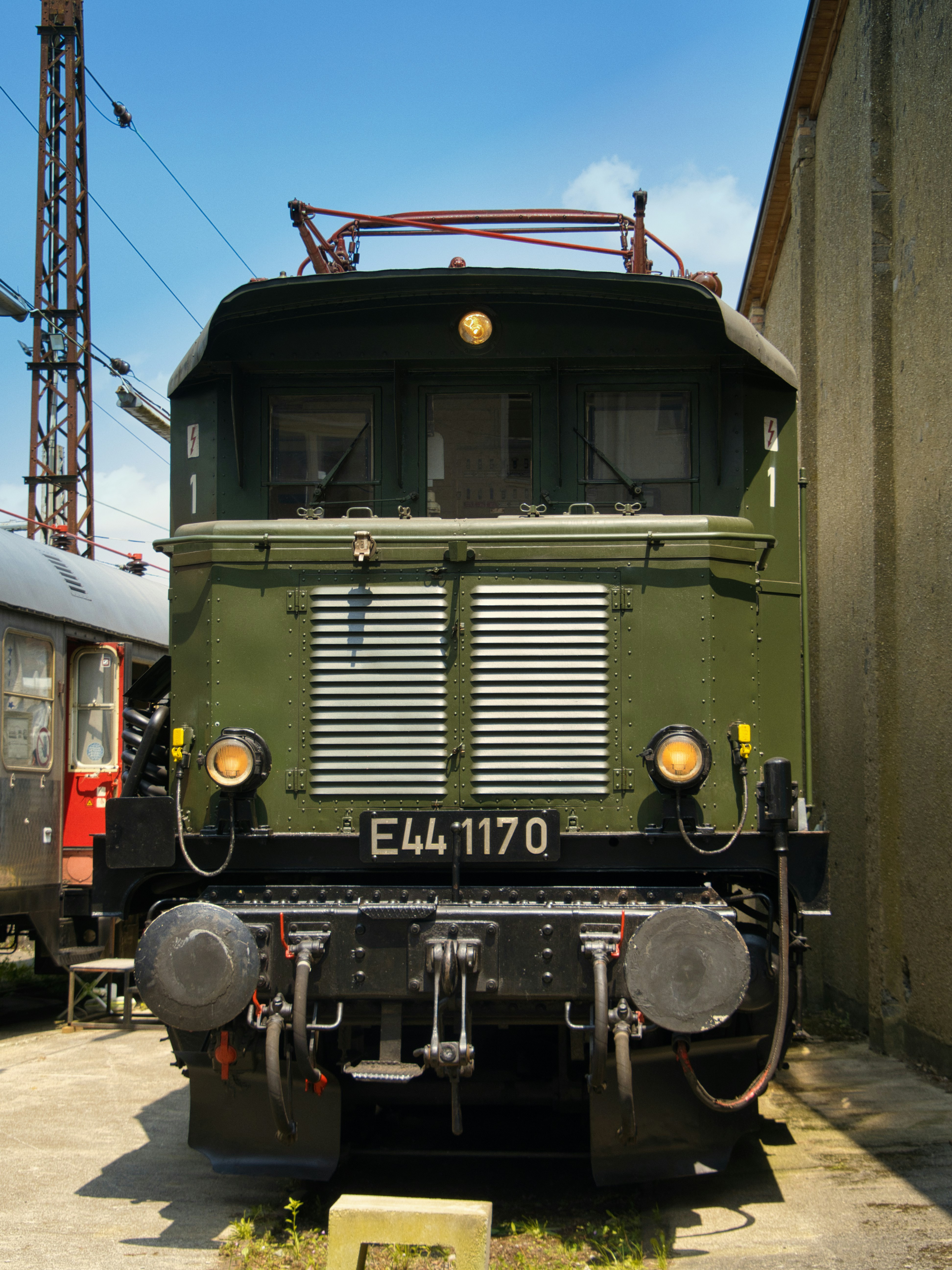 A green, vintage electric train locomotive is pictured.