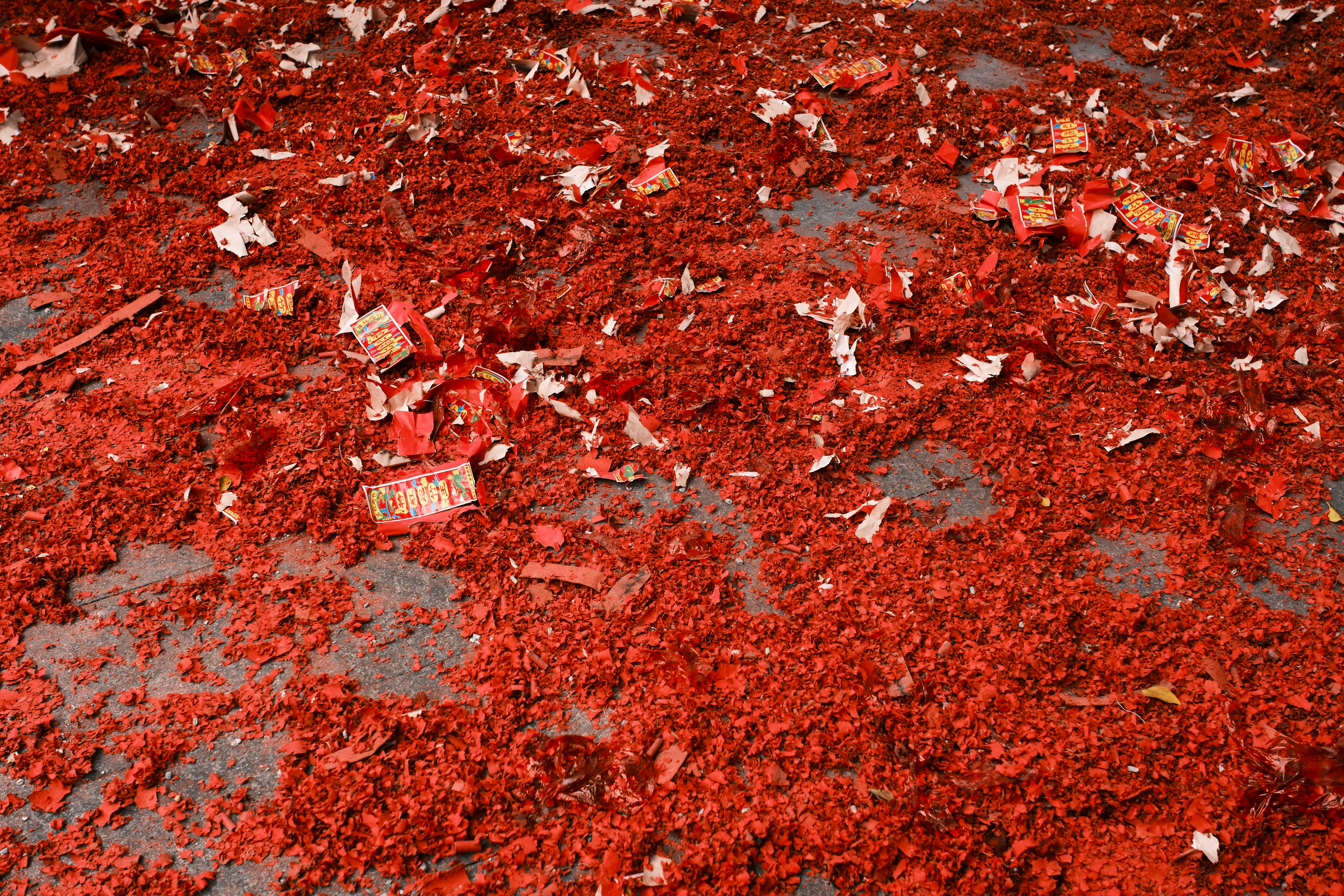 Remains of a firecracker celebration cover the ground.