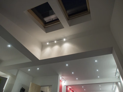 A ceiling design with skylights and recessed lighting