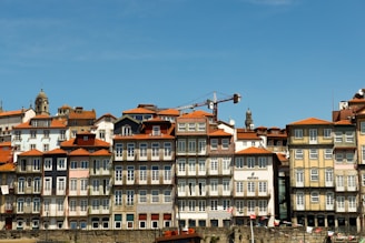 Colorful buildings line a waterfront under a blue sky.