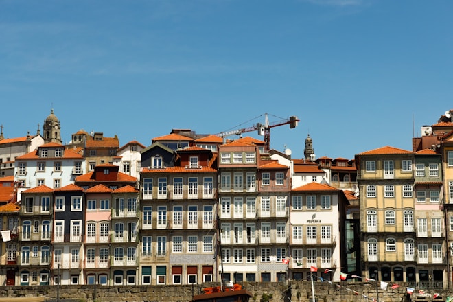 Colorful buildings line a waterfront under a blue sky.
