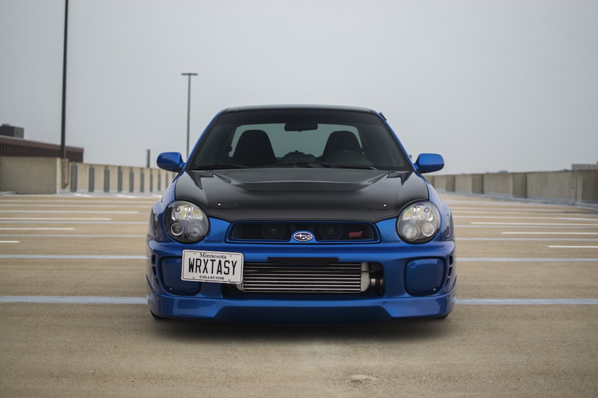 Blue Subaru WRX STI front view in an open lot