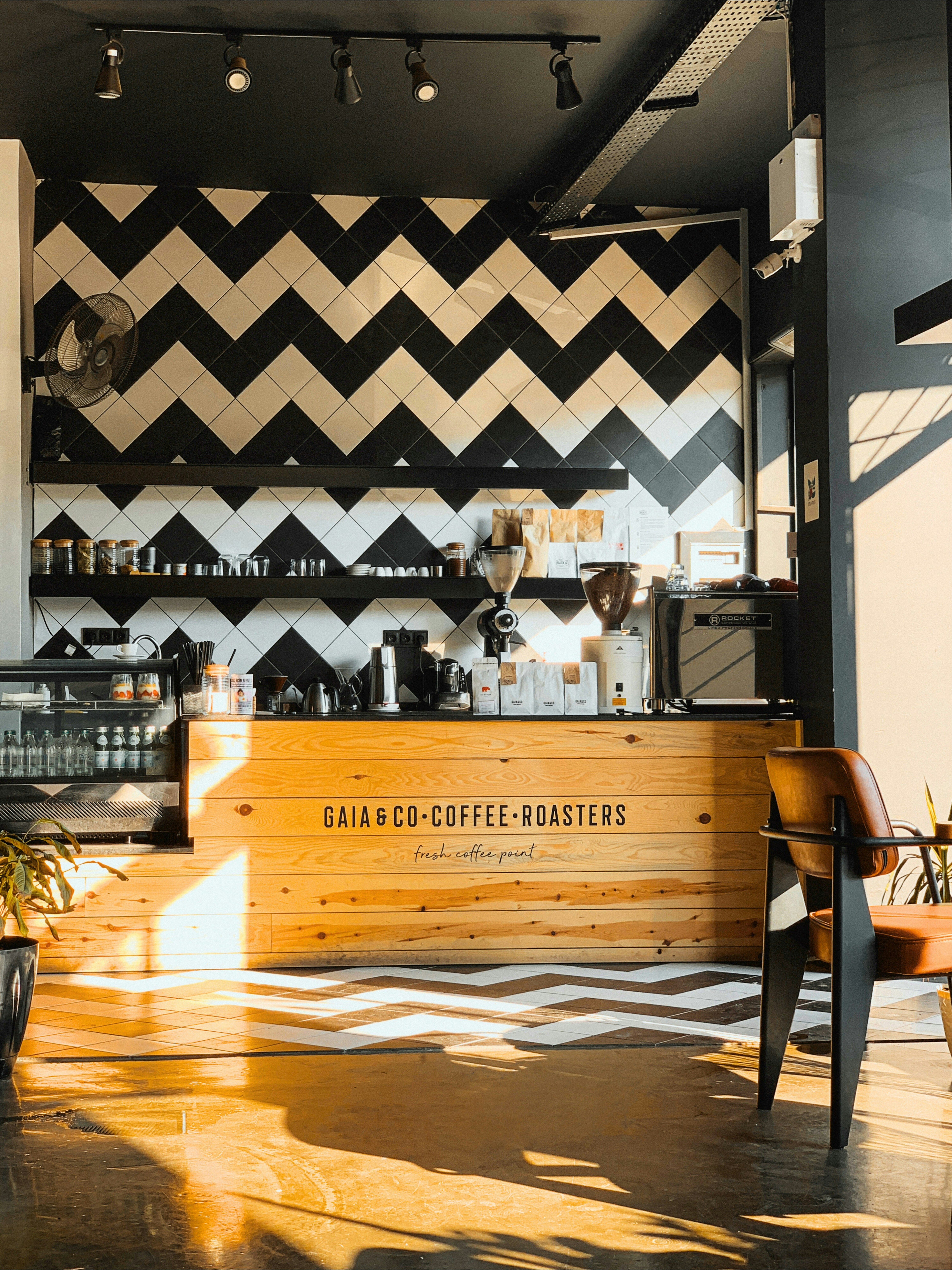 A stylish coffee shop interior with a patterned wall.