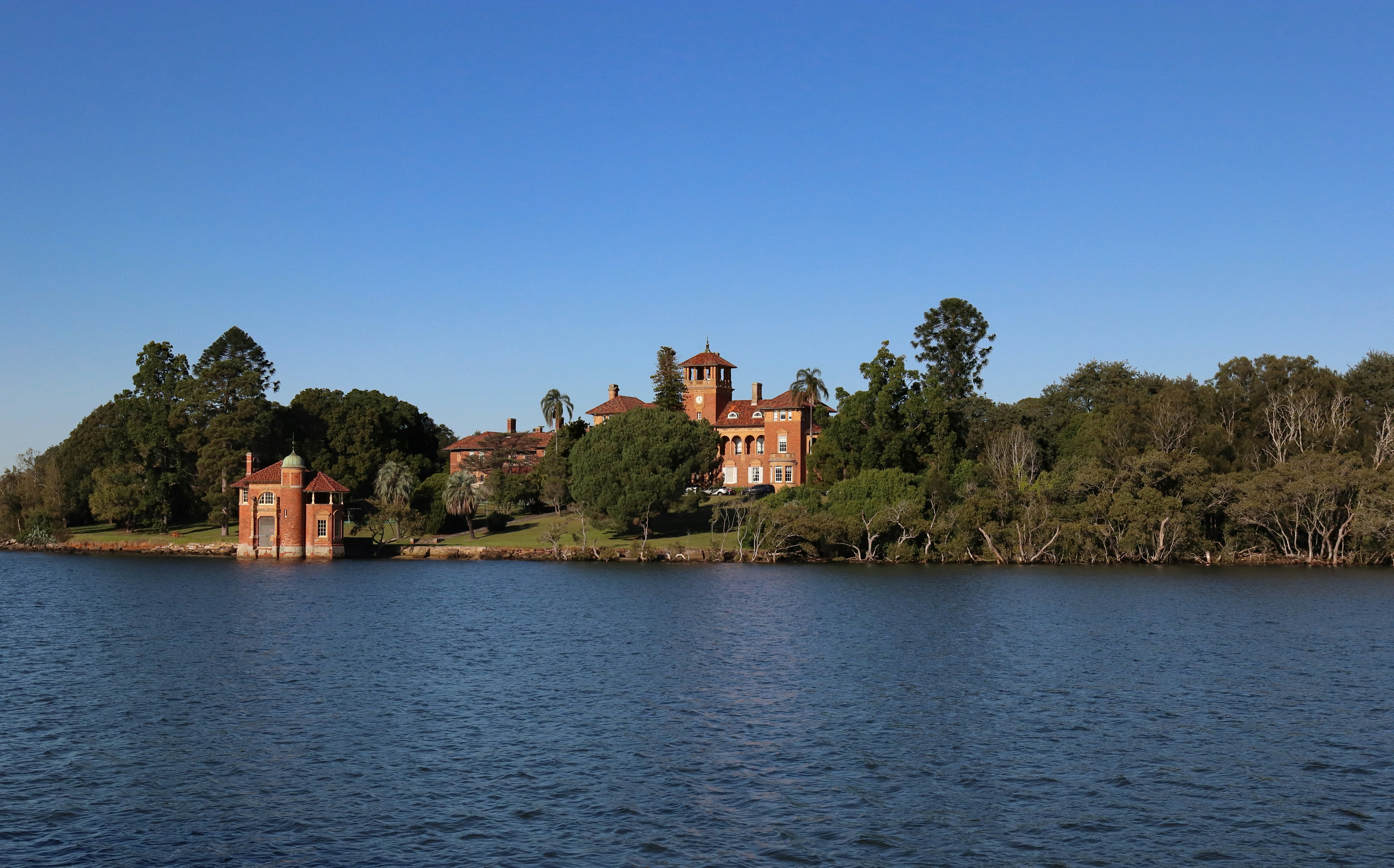 A grand, historic building sits on a body of water.