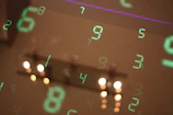 Numbers are reflected on a surface, blurring the image