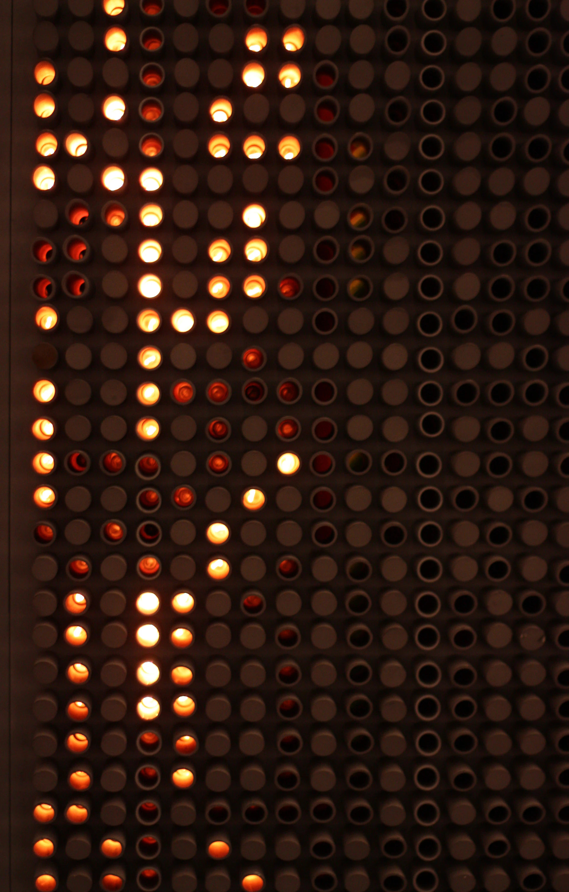 Glowing dots create a shape against a dark background.