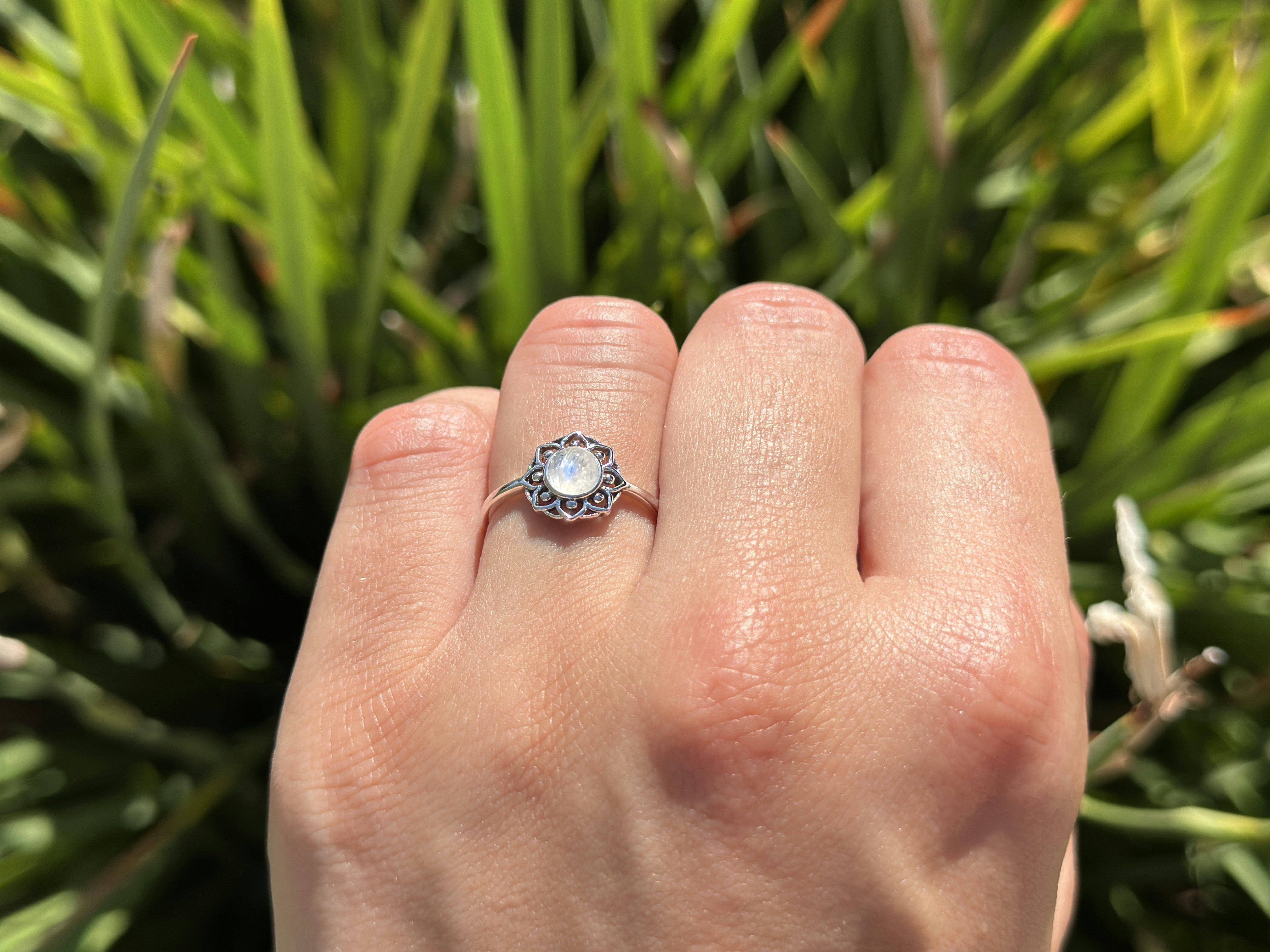 A hand displays a beautiful ring.