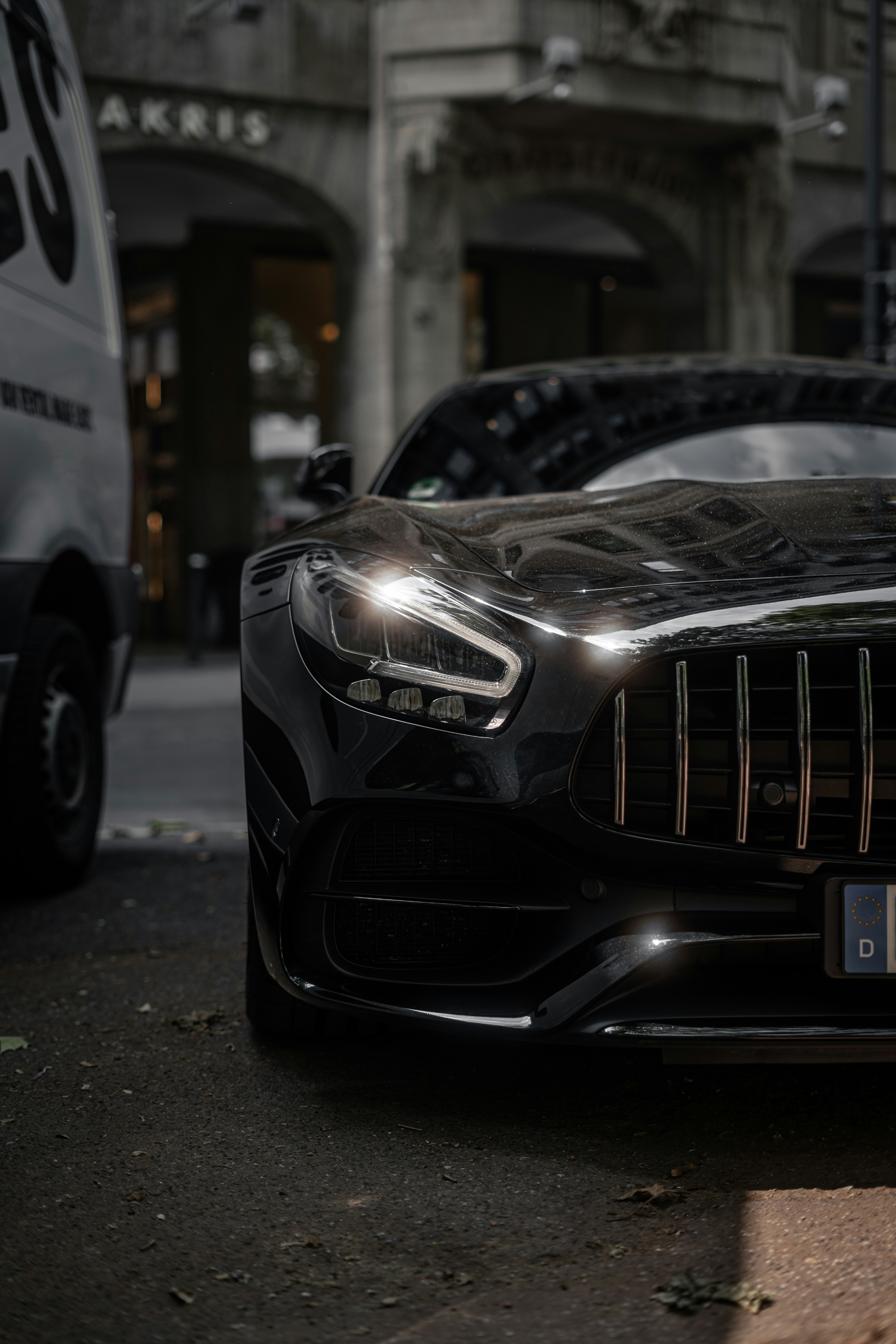 A sleek black sports car parked on a street.