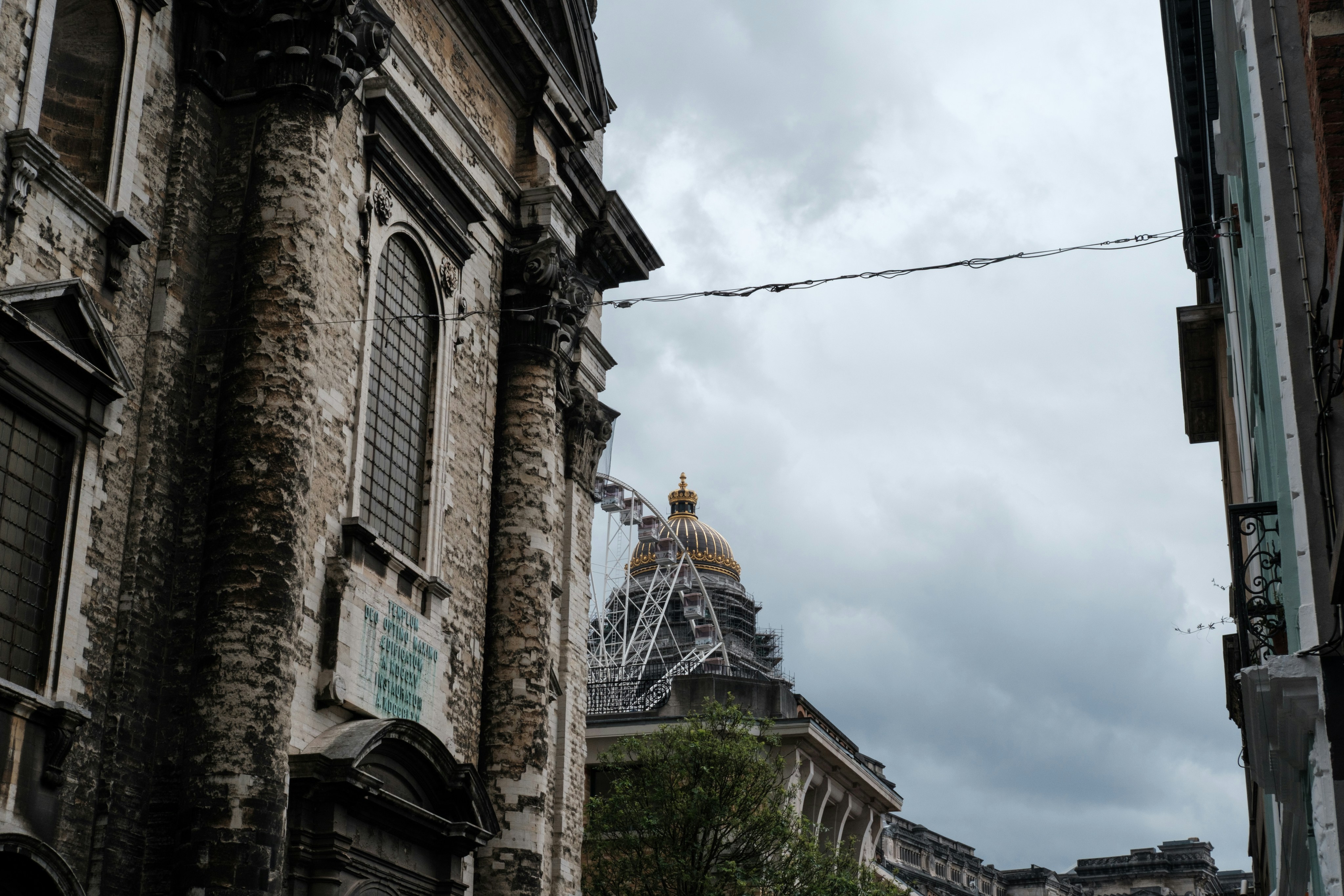 Buildings are framed against a cloudy sky.