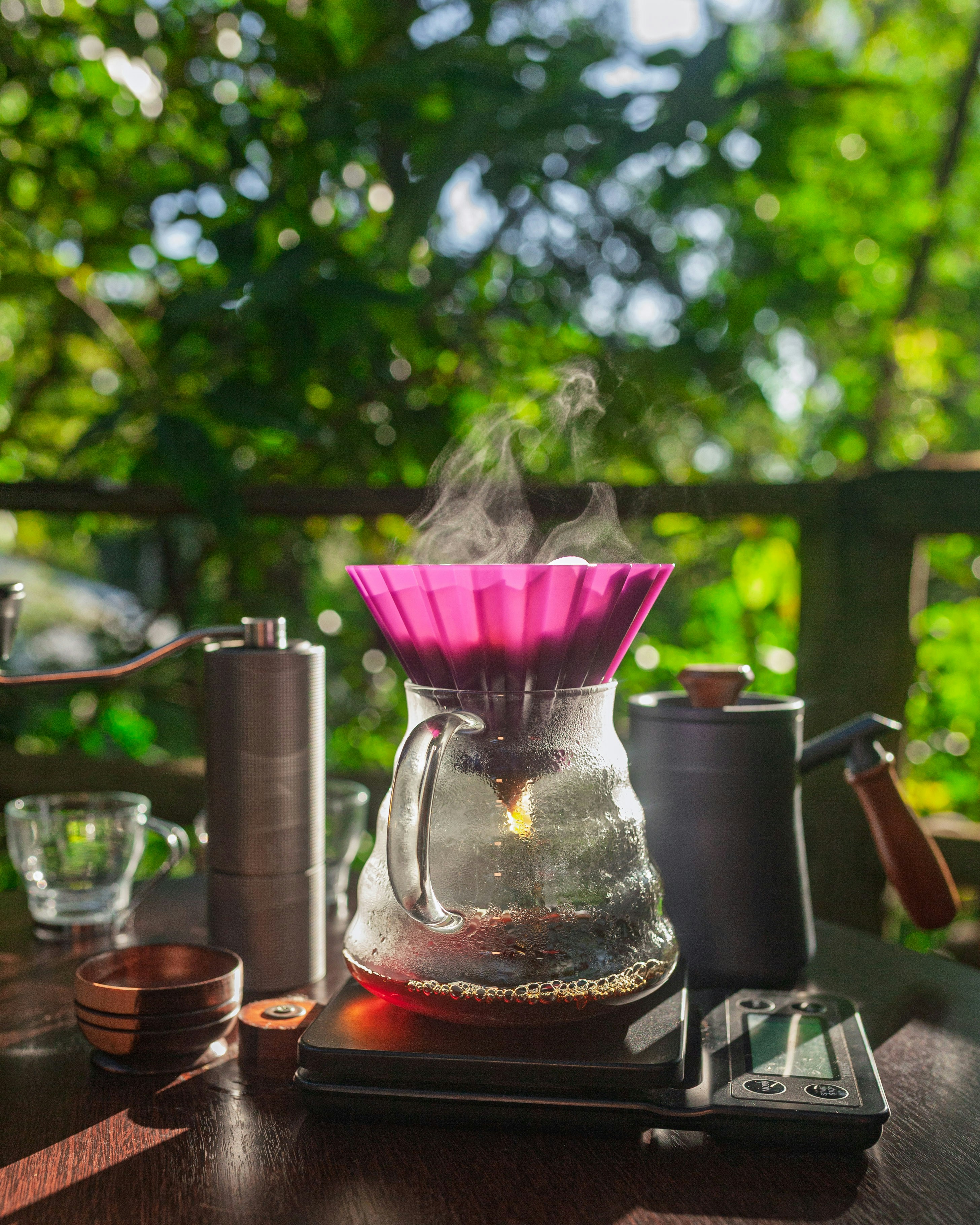 Freshly brewed coffee steams in a beautiful setting.
