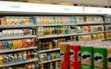 Shelves of snacks and drinks inside a 7-eleven.