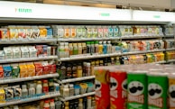 Shelves of snacks and drinks inside a 7-eleven.