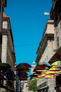 Colorful umbrellas decorate a city street.