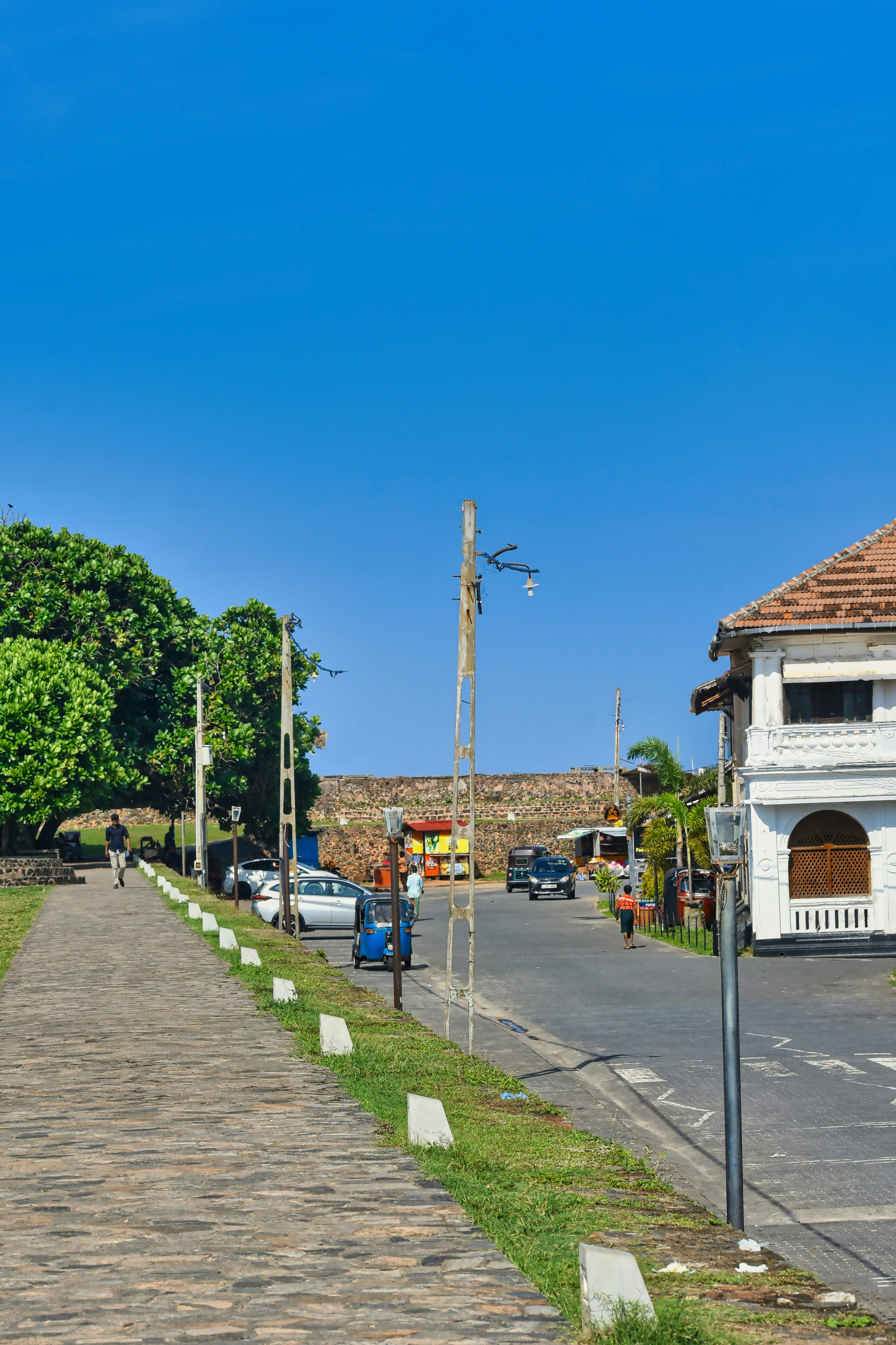 Street scene with old buildings under blue sky.
