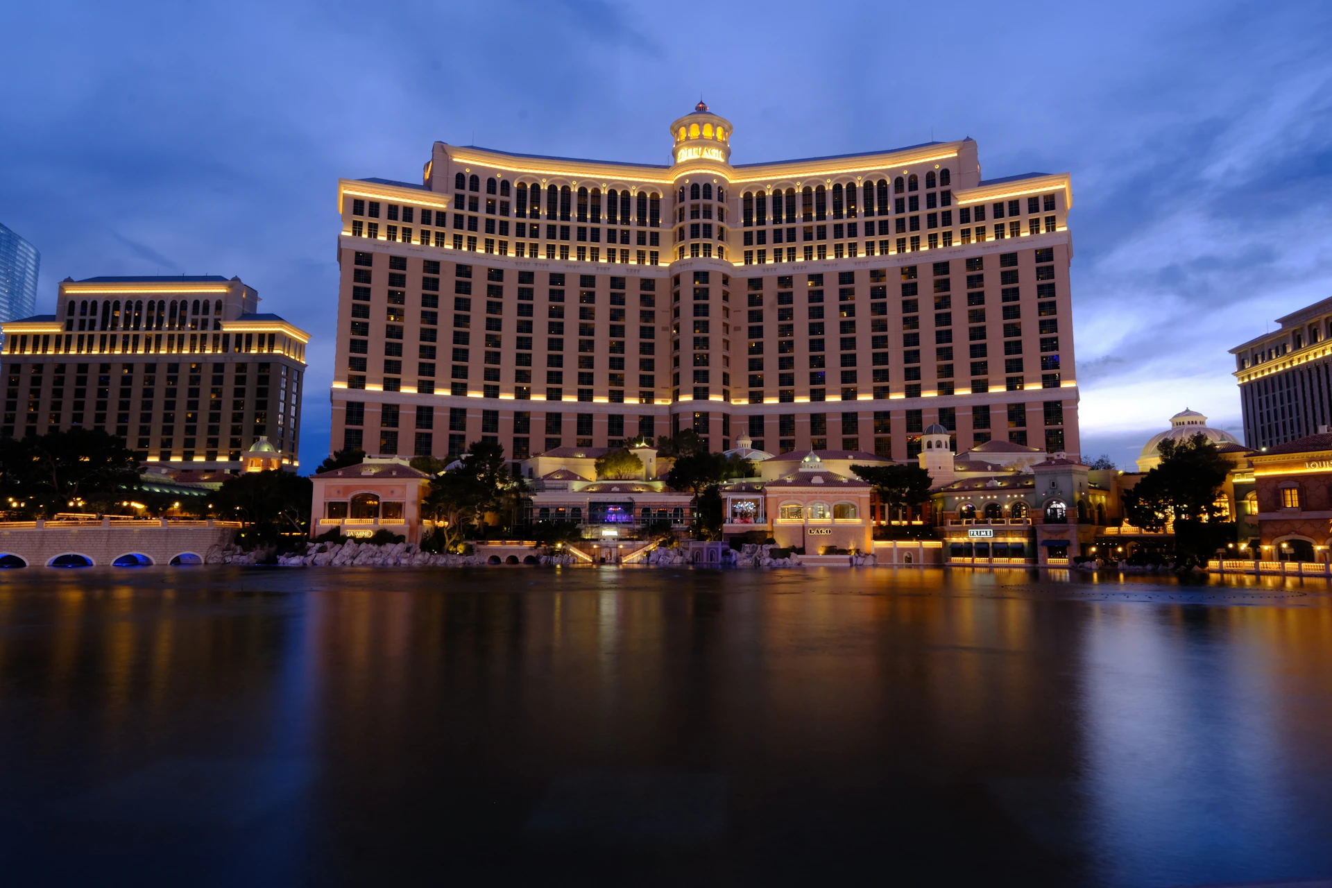 The Bellagio-style casino hotel tower lit up at night on the Las Vegas strip