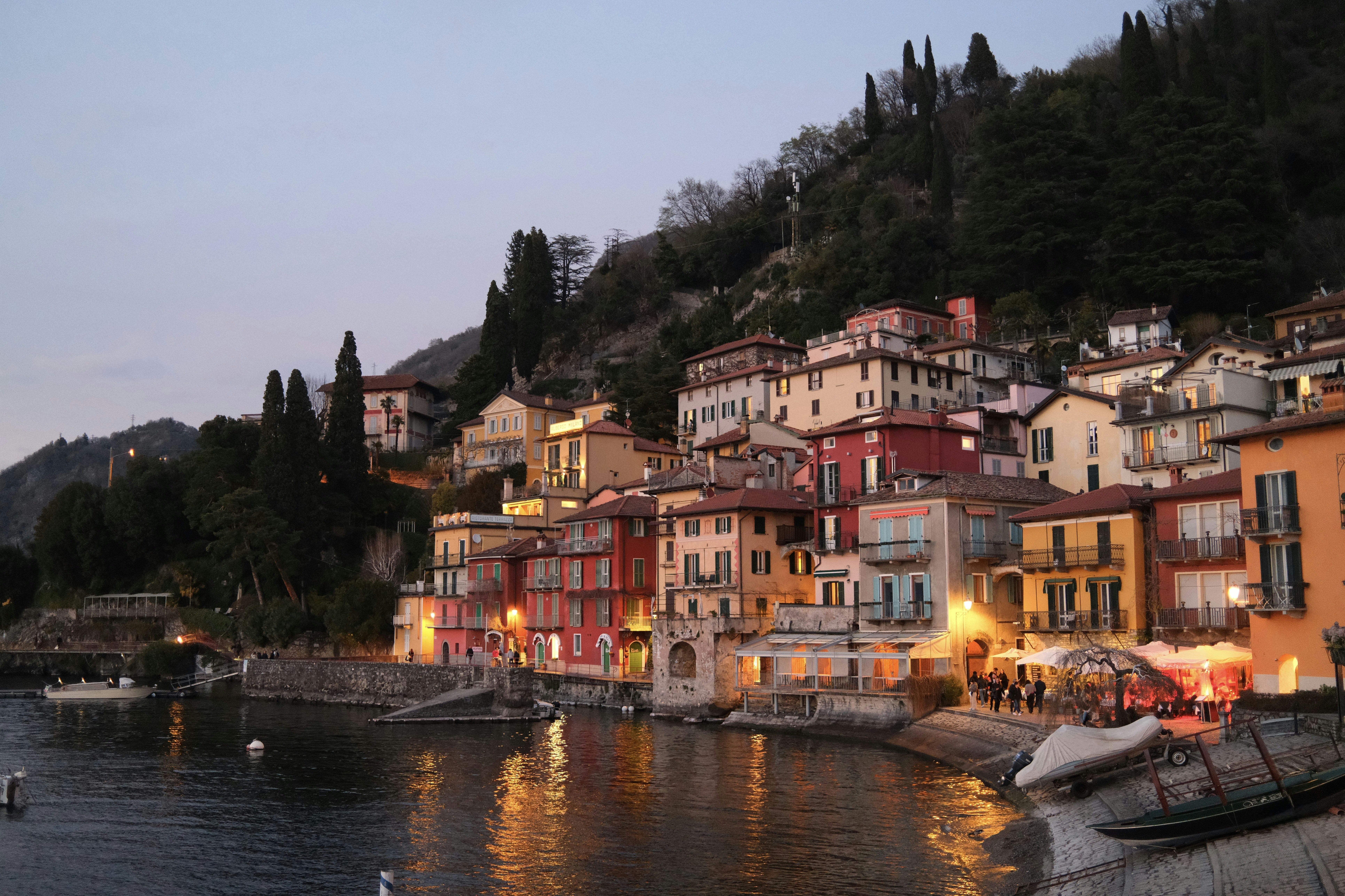 Colorful buildings line a serene waterfront.