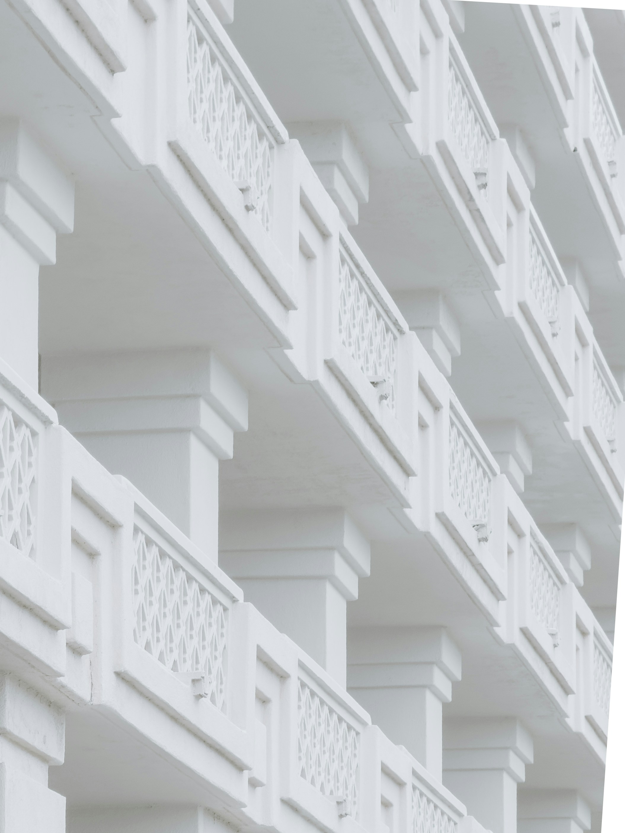 Rows of white balconies on a building.