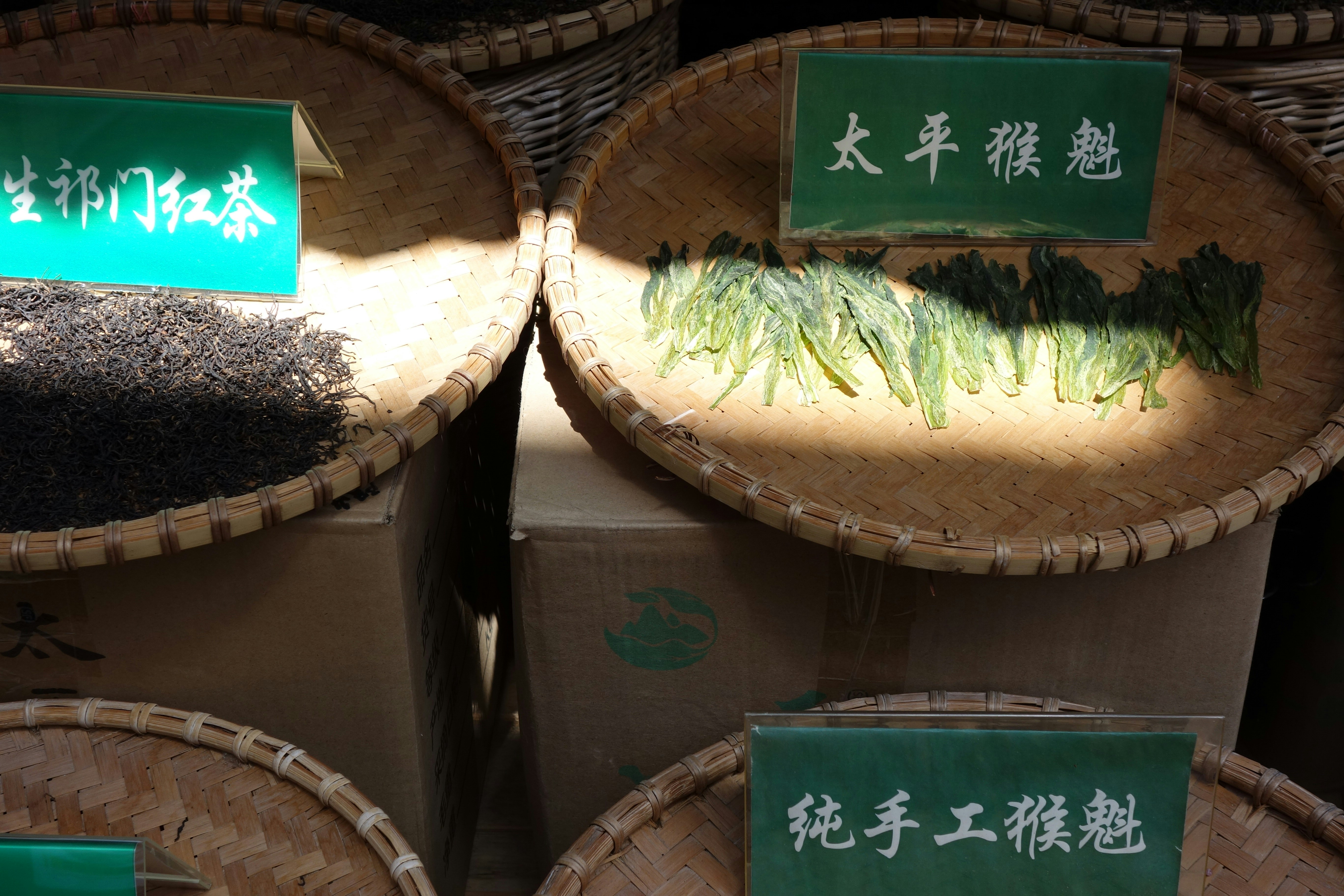 Tea leaves are displayed in woven baskets