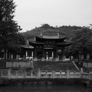 A temple is seen from across the water.
