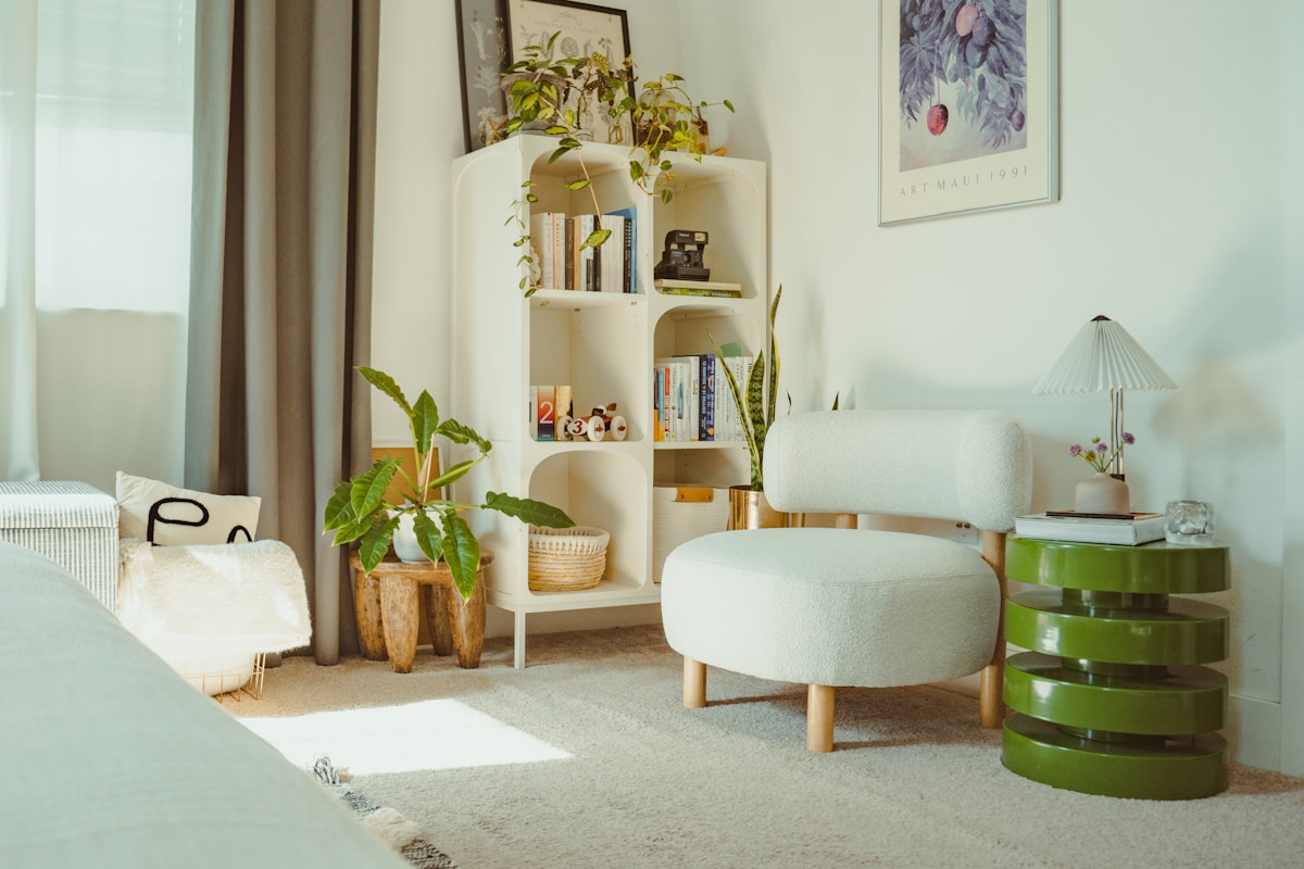 cozy apartment reading corner with white bookshelf, indoor plants, and round accent chair
