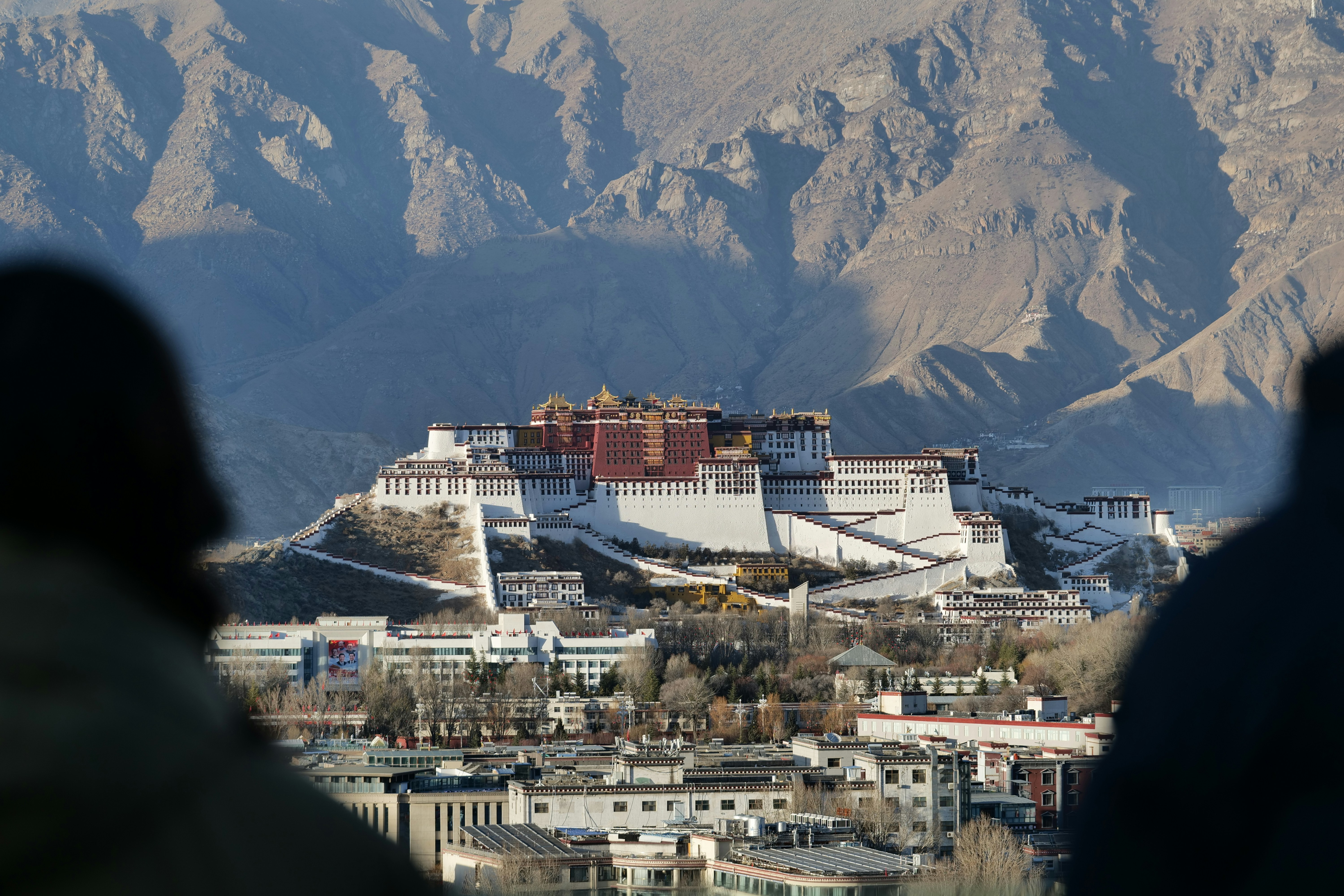 The potala palace stands majestically in the distance.