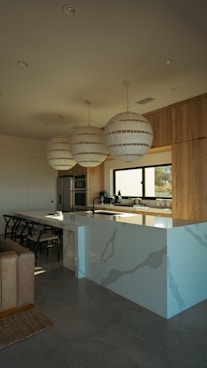 Modern kitchen island with pendant lights and wooden cabinets